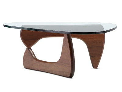 A Noguchi Table by Herman Miller with walnut legs and a clear glass tabletop