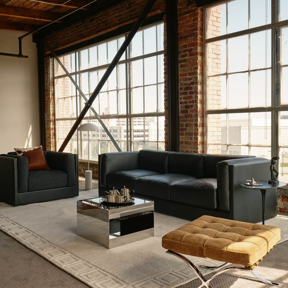 Symme three-seat sofa in Obsidian leather, Symme Armchair and D'Urso Coffee Table