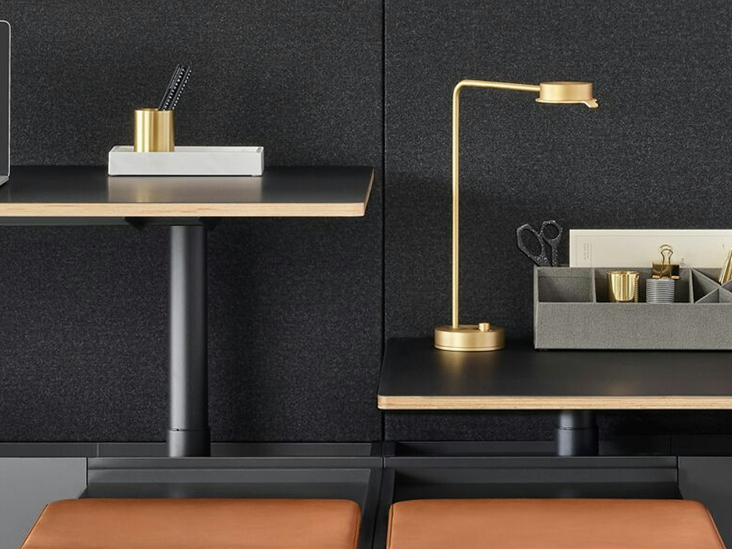 A two-pack Geiger One Casegoods bench system. One workstation is at standing height while the other is at sitting height.