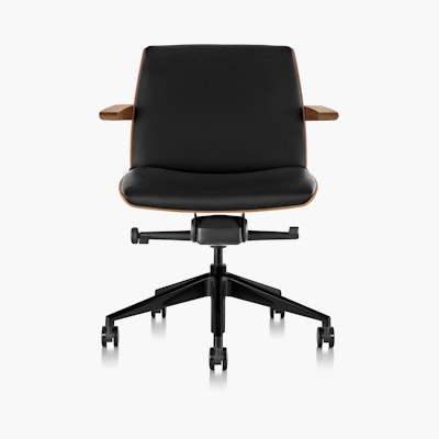 Front  view of a low-back Clamshell office chair with black leather upholstery, a walnut shell, with arms. Front  view of a low-back Clamshell office chair with black leather upholstery, a walnut shell, with arms.