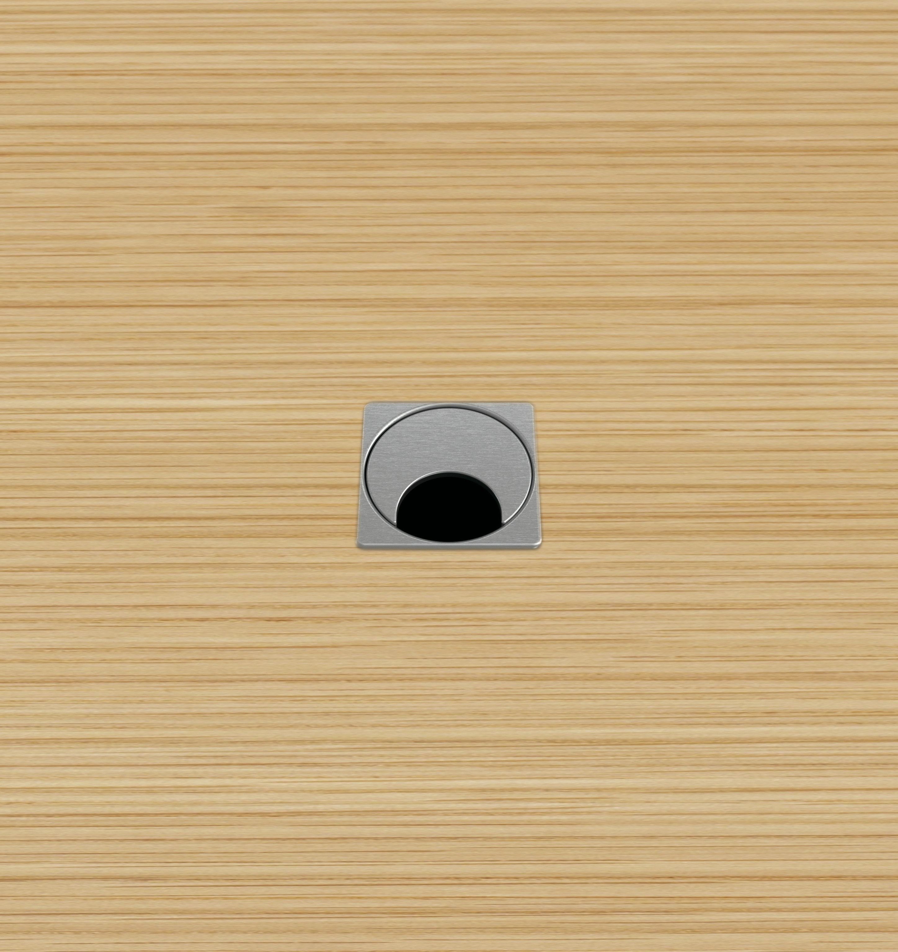 Close-up of the MP Small grommet option for MP Height-Adjustable Tables, which is square with a rotating half-moon opening for cables.