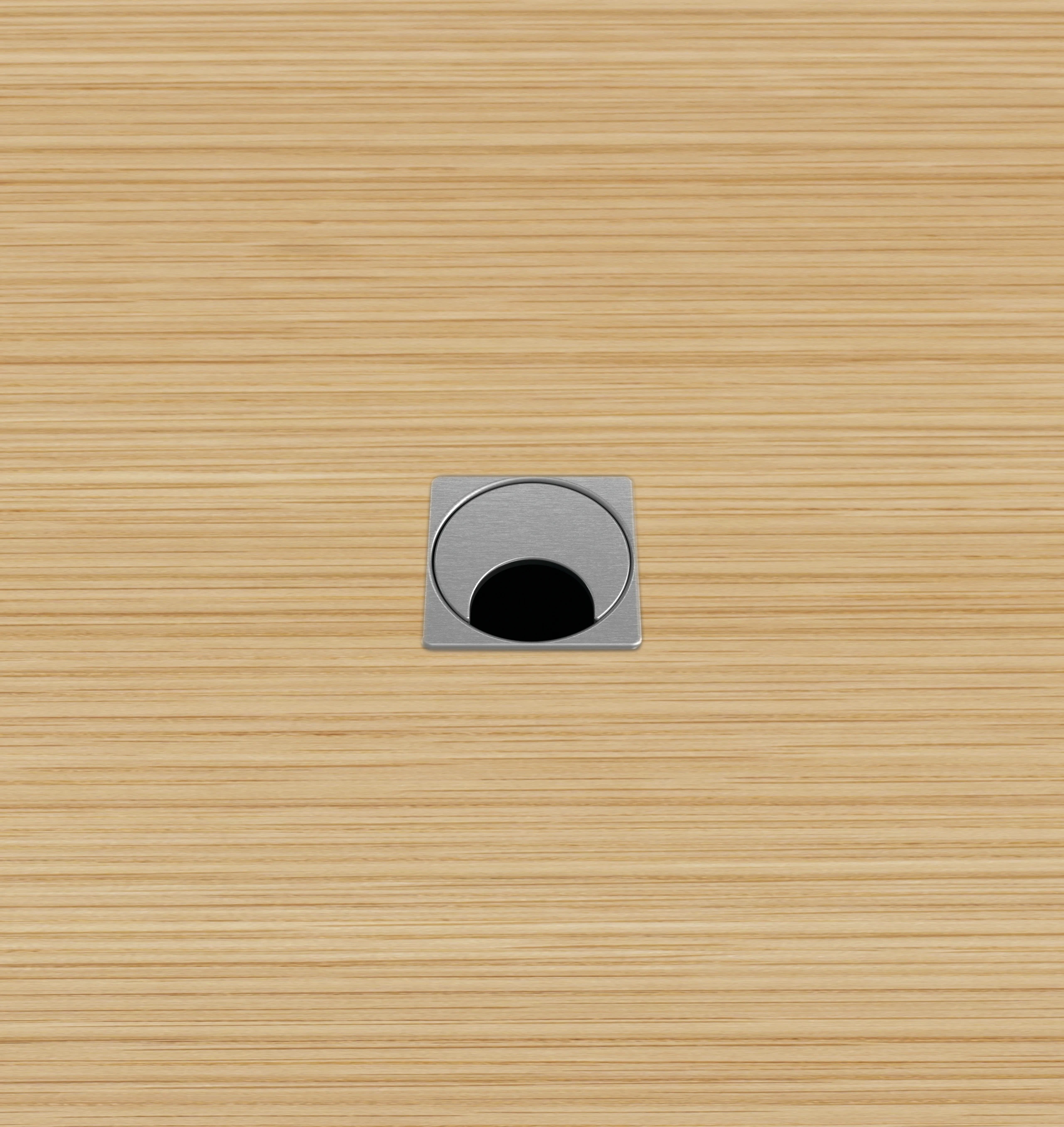Close-up of the MP Small grommet option for MP Height-Adjustable Tables, which is square with a rotating half-moon opening for cables.