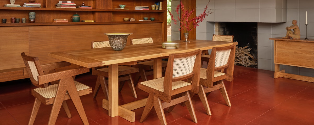 Land Dining Table surrounding by dining chairs in a dining room setting