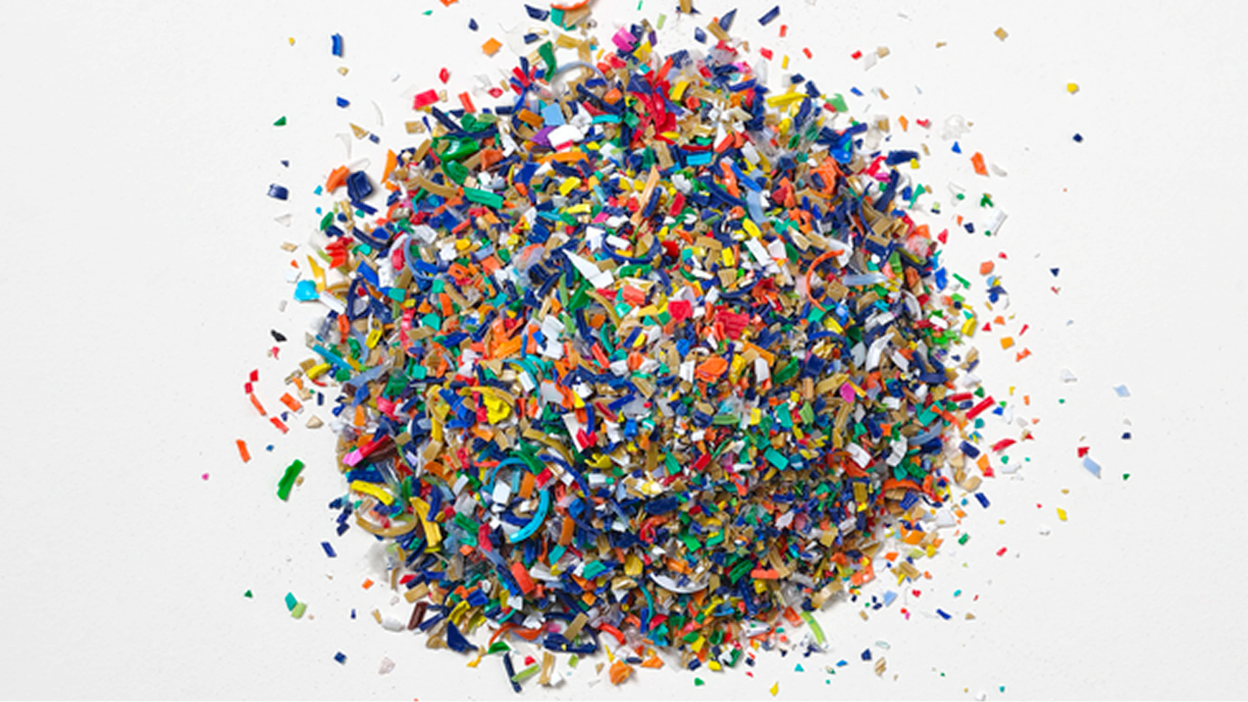 Colorful pile of recycled plastic pieces.
