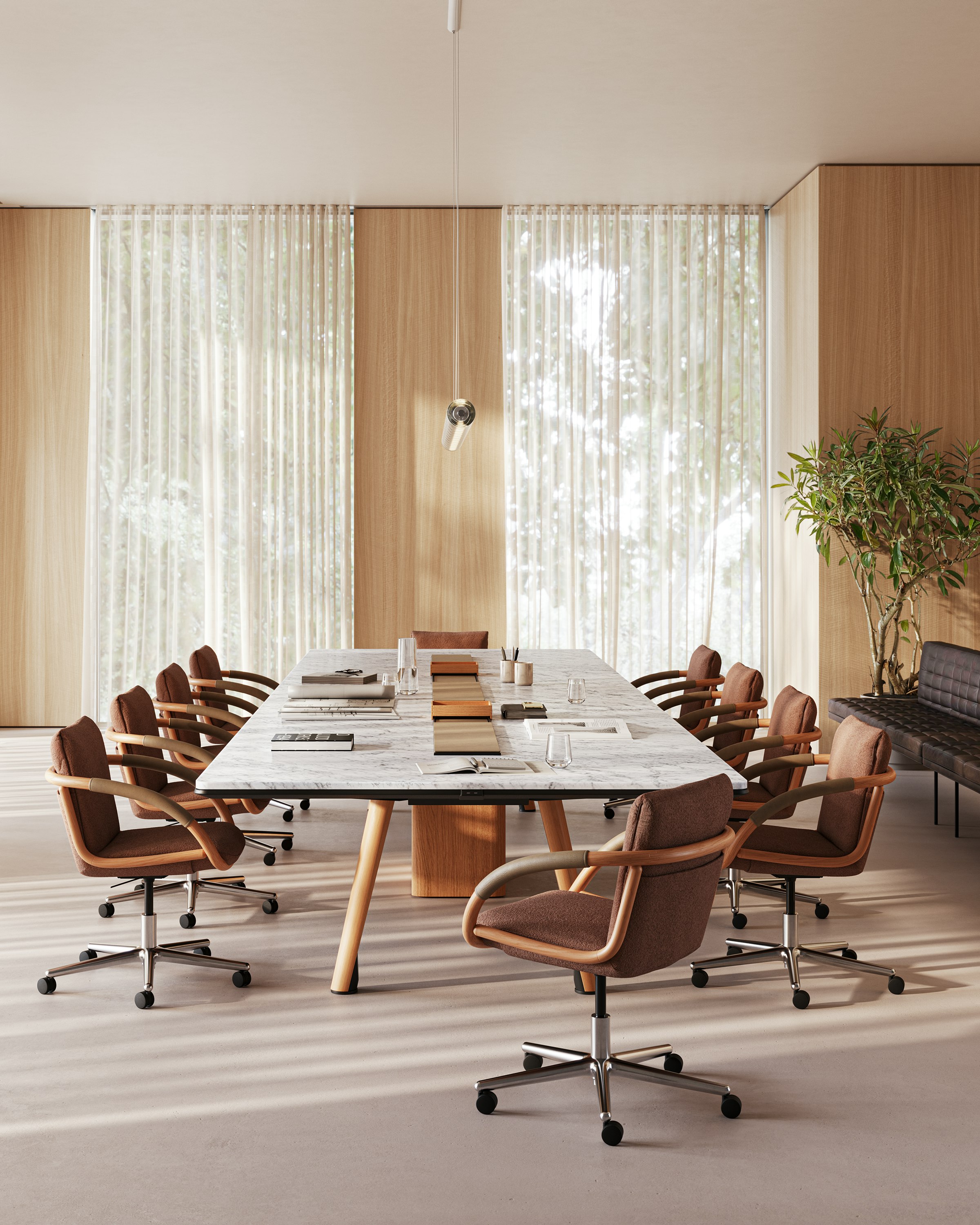 Ascent Conference Table designed by EOOS, shown in White Carrara Marble with a Natural Rift Cut Oak base, with Full Loop Chairs viewed from the side in a boardroom setting.