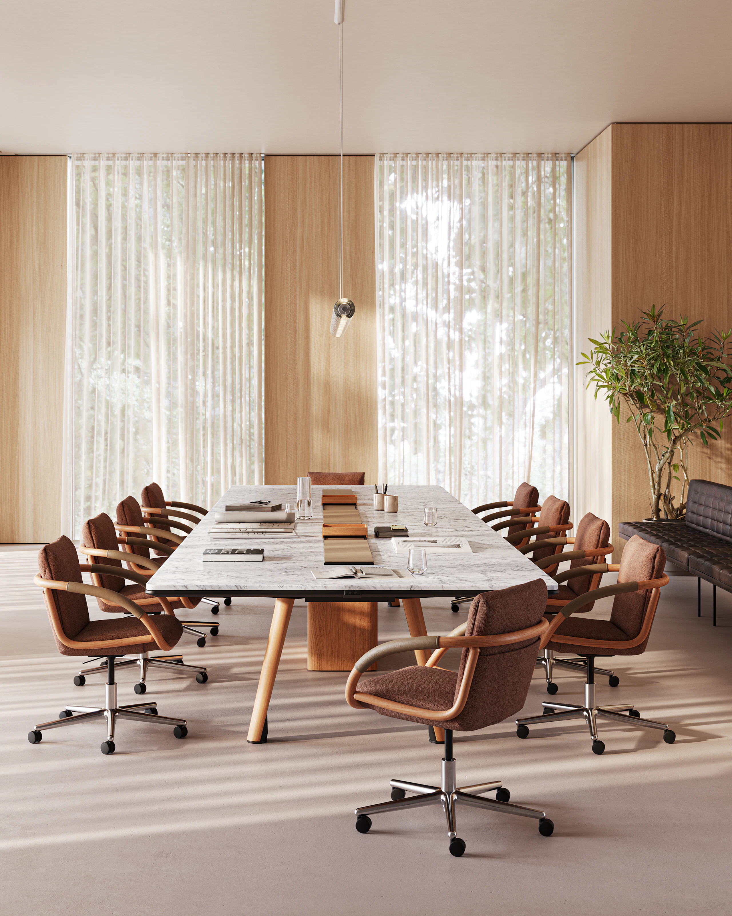 Ascent Conference Table designed by EOOS, shown in White Carrara Marble with a Natural Rift Cut Oak base, with Full Loop Chairs viewed from the side in a boardroom setting.