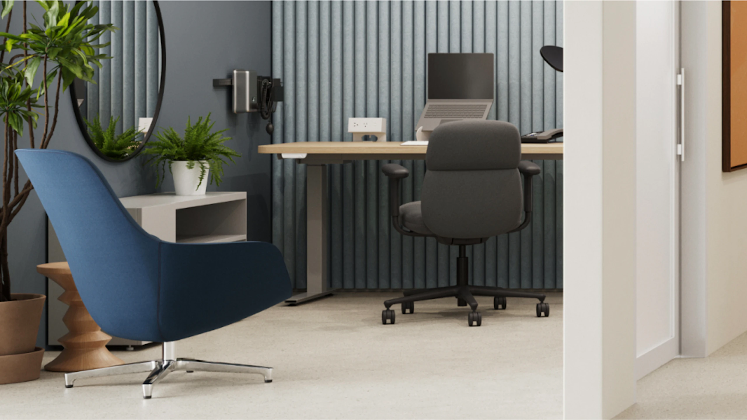 Blue armchair in the foreground, a standing desk with a laptop and office chair in the background, slatted wall paneling, and plants. A curved mirror reflects the space