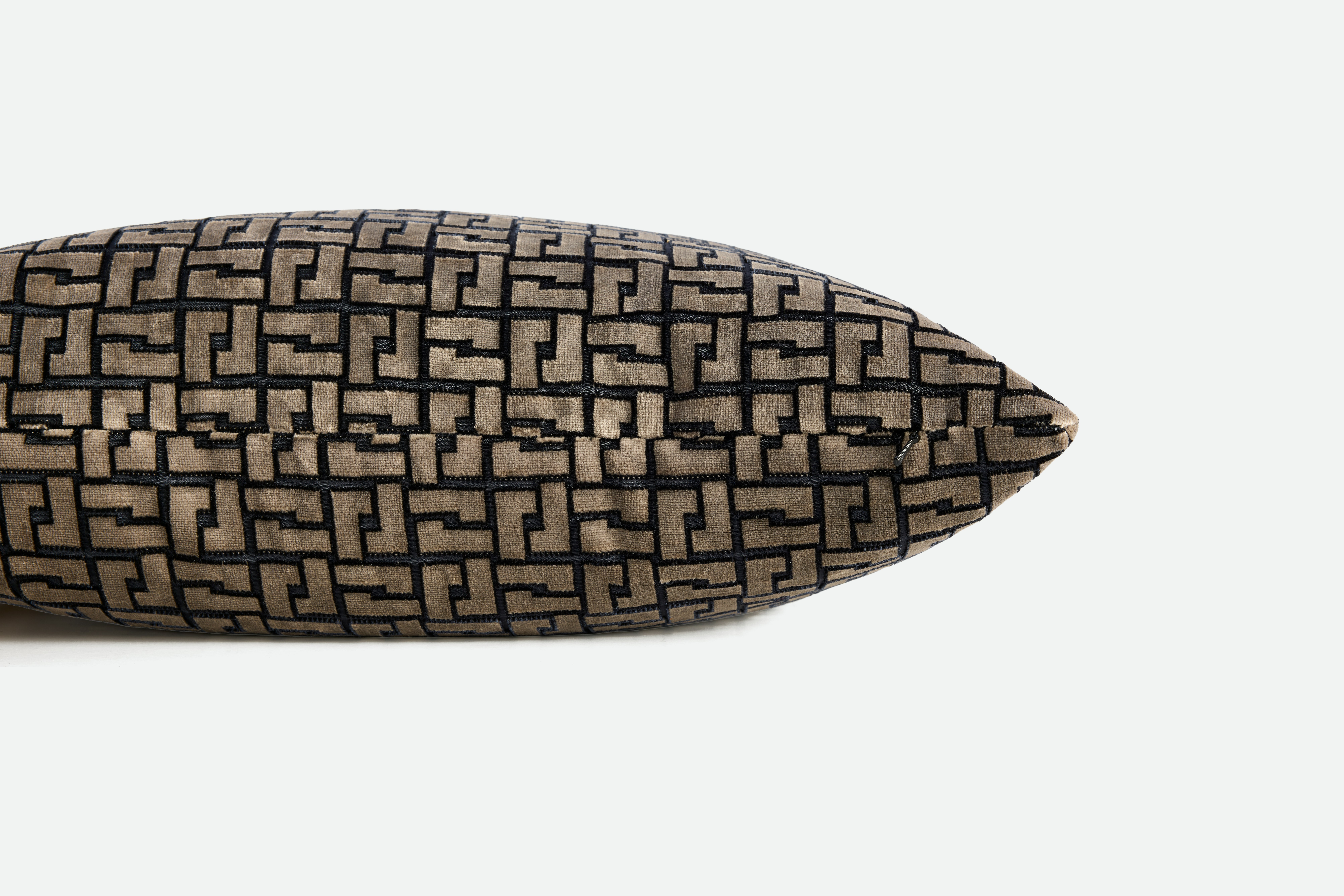 A detailed look at a Holly Hunt Interlock Pillow in Bronze Night.