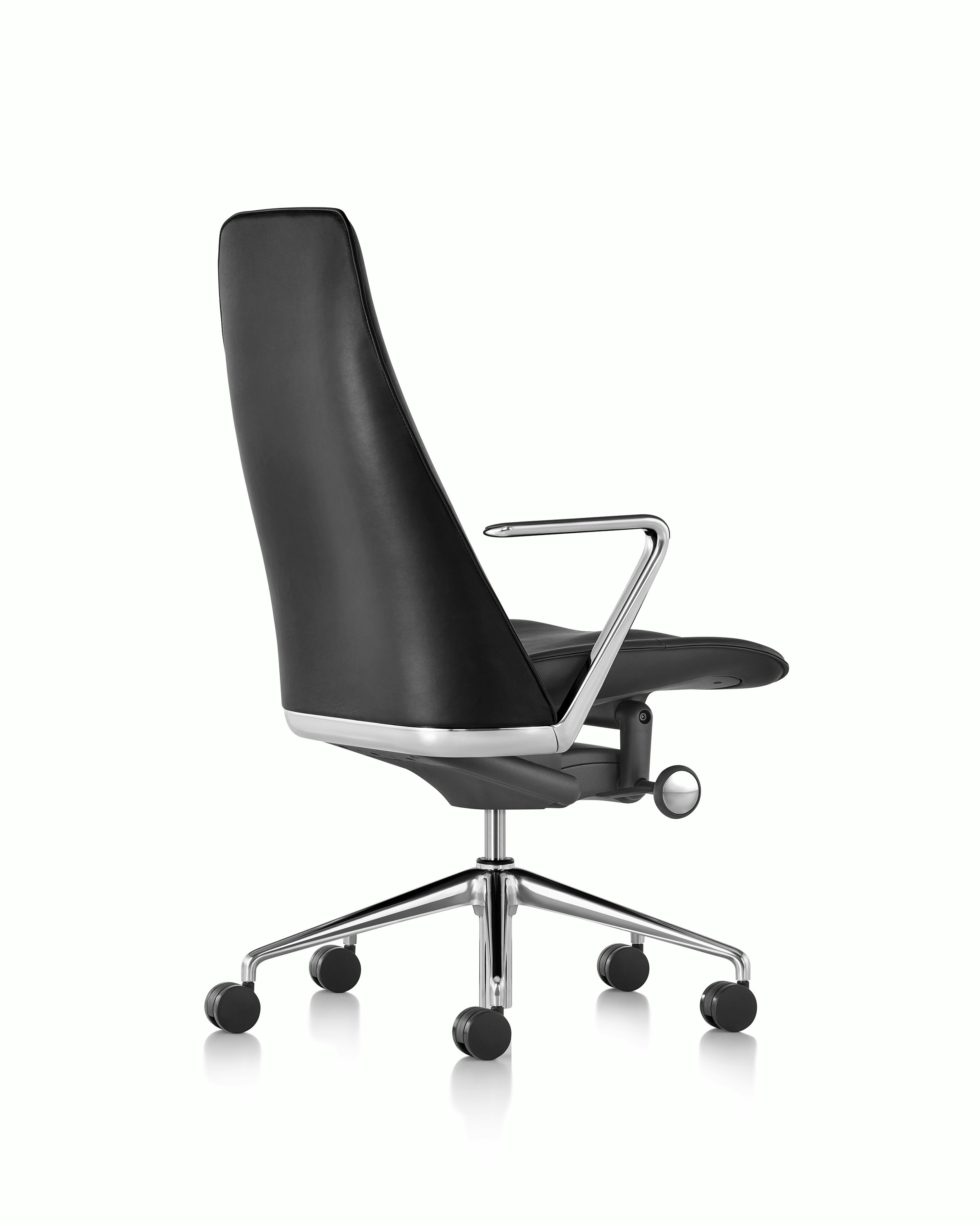 The seat, arm, and lower back of a black leather Taper office chair, viewed from behind at an angle.