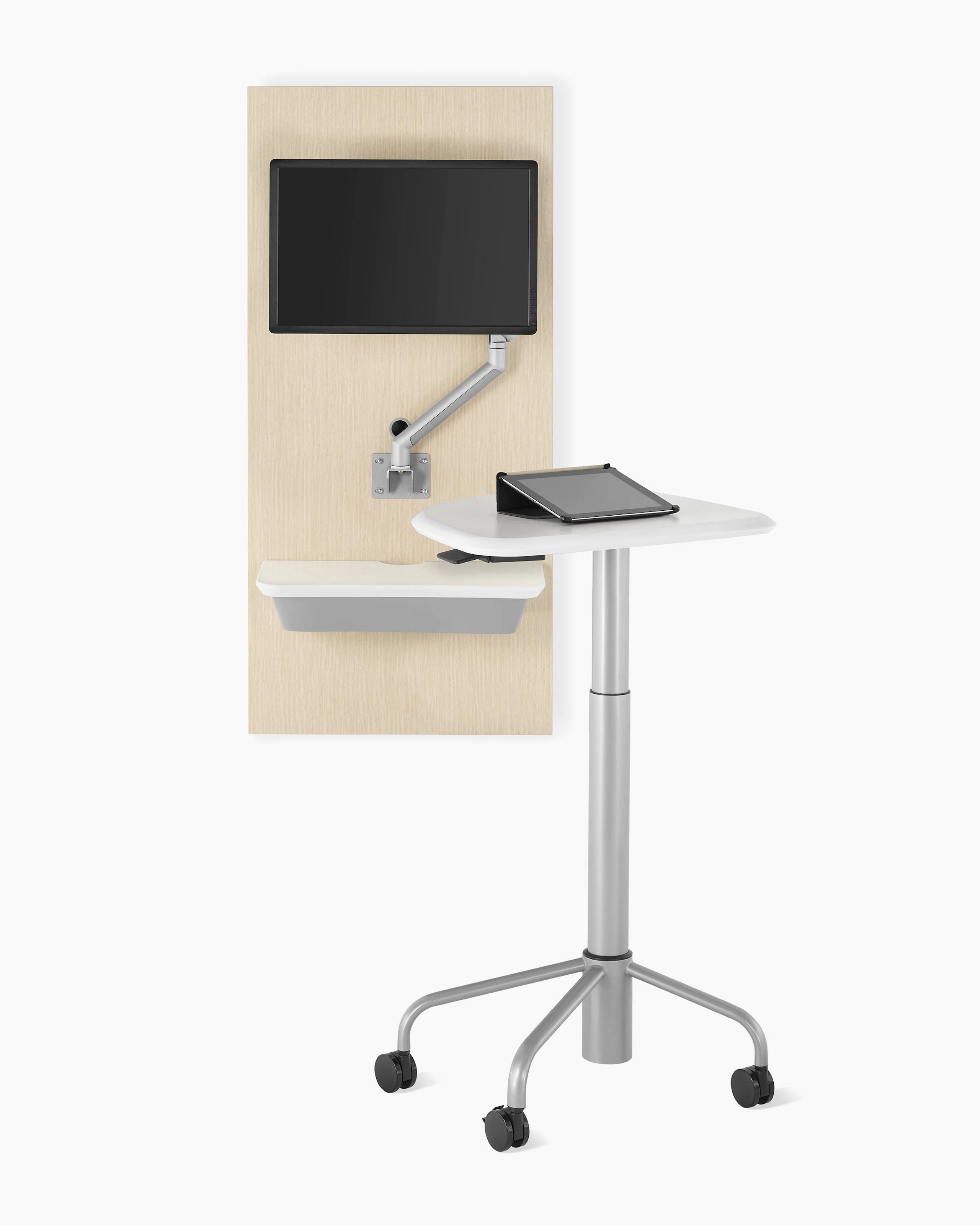An Intent Solution technology support wall unit in an ash wood finish with an Intent Solution mobile, height-adjustable table.