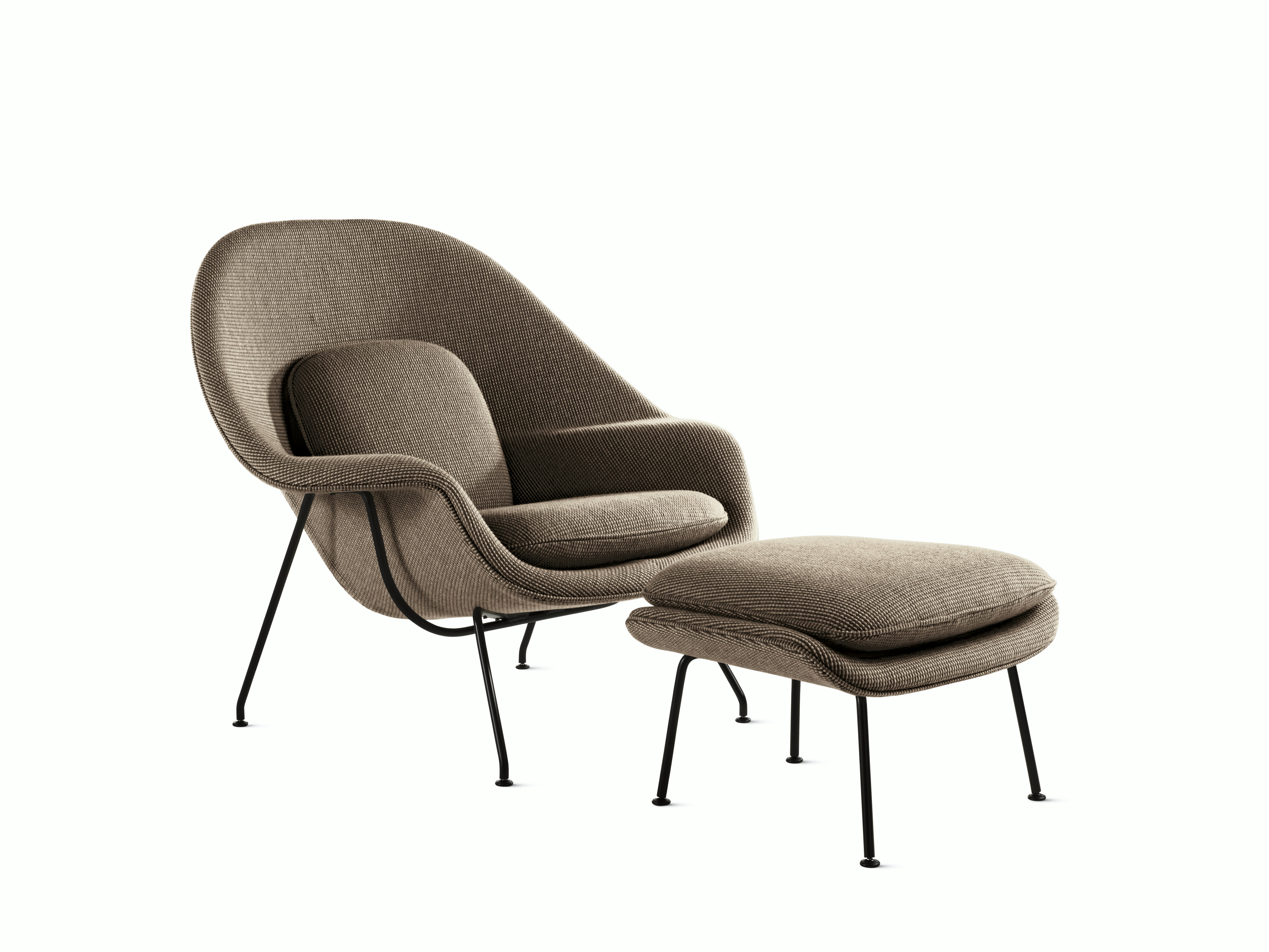 A sand Womb Chair & Ottoman viewed from an angle