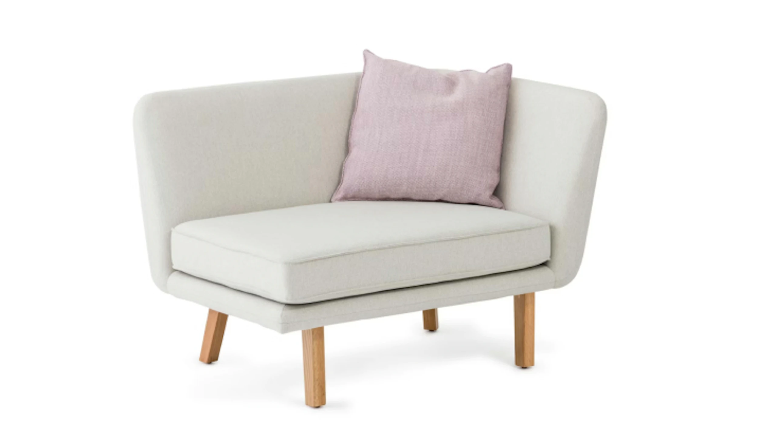 Rockwell Unscripted Modular lounge chair by Knoll with wraparound arms, wooden legs, and a pink accent pillow.