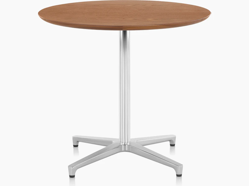 A round Saiba occasional table with a veneer top and aluminum pedestal base.