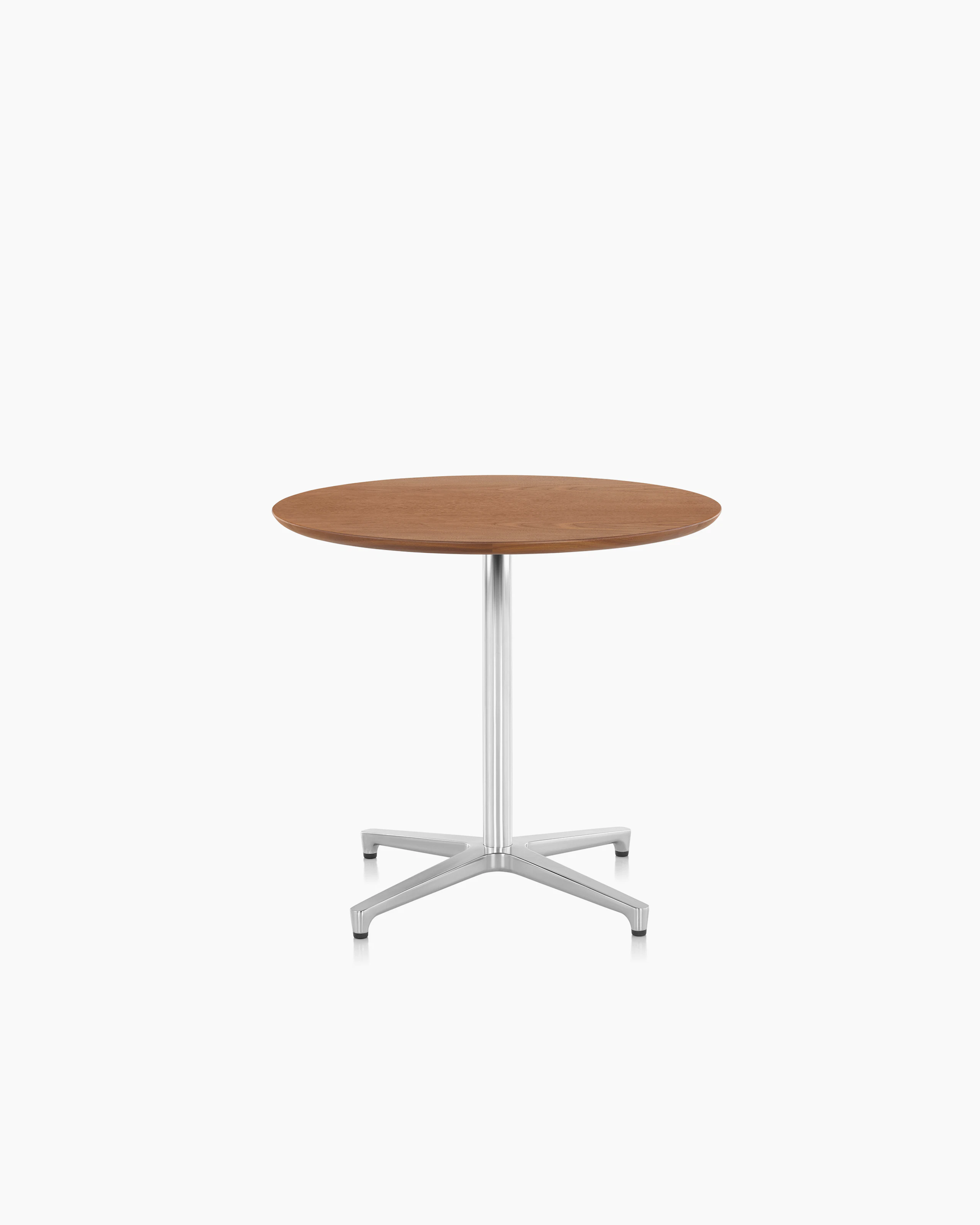 A round Saiba occasional table with a veneer top and aluminum pedestal base.