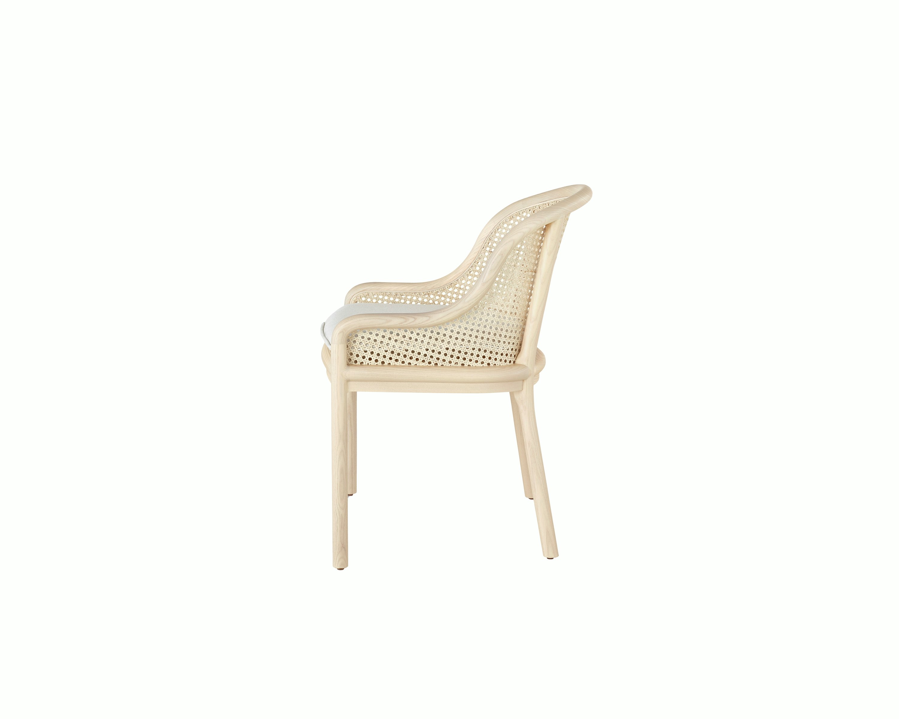 Landmark Chair with a cane back and a seat upholstered in a Double Beam textile, viewed from the side.
