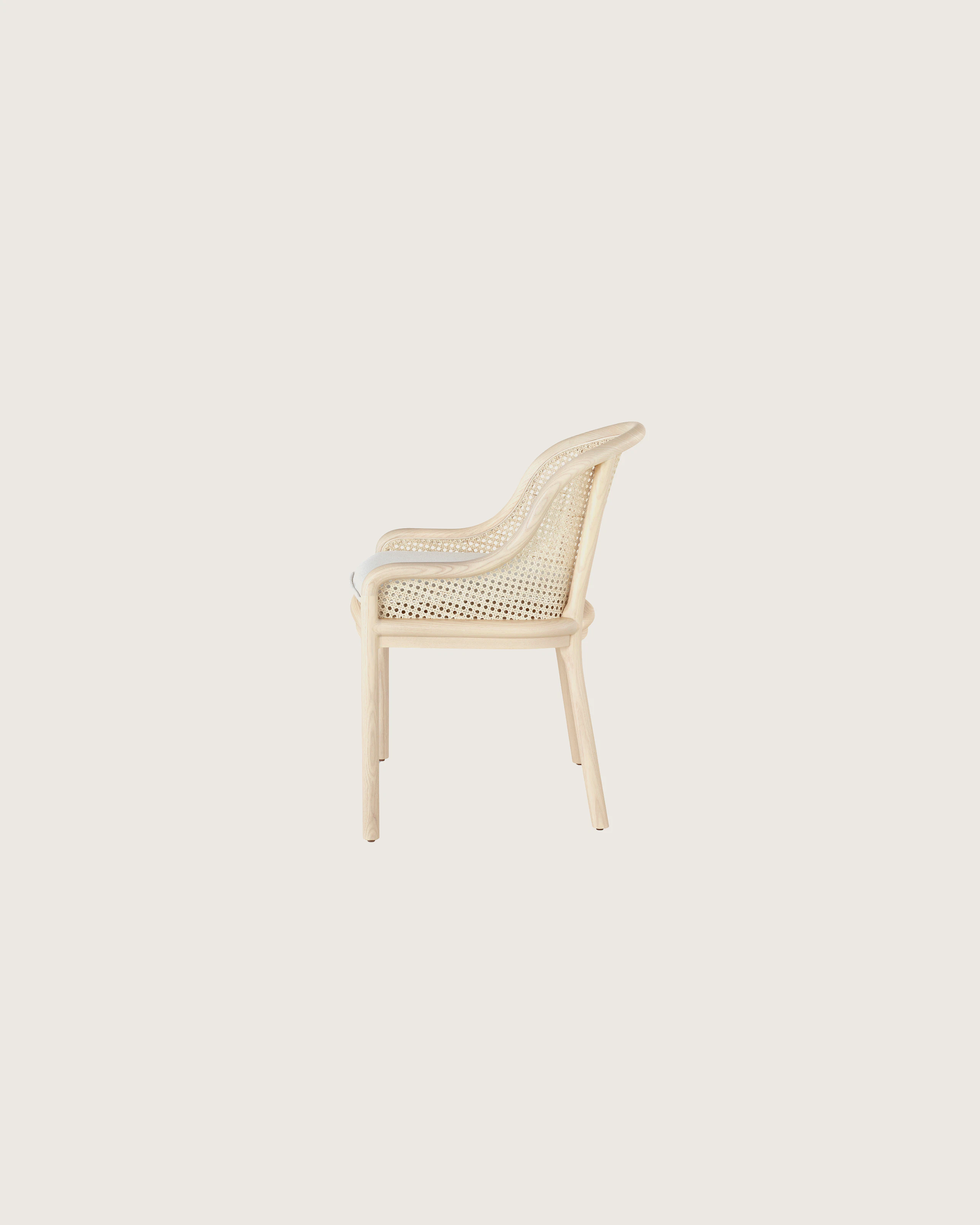Landmark Chair with a cane back and a seat upholstered in a Double Beam textile, viewed from the side.