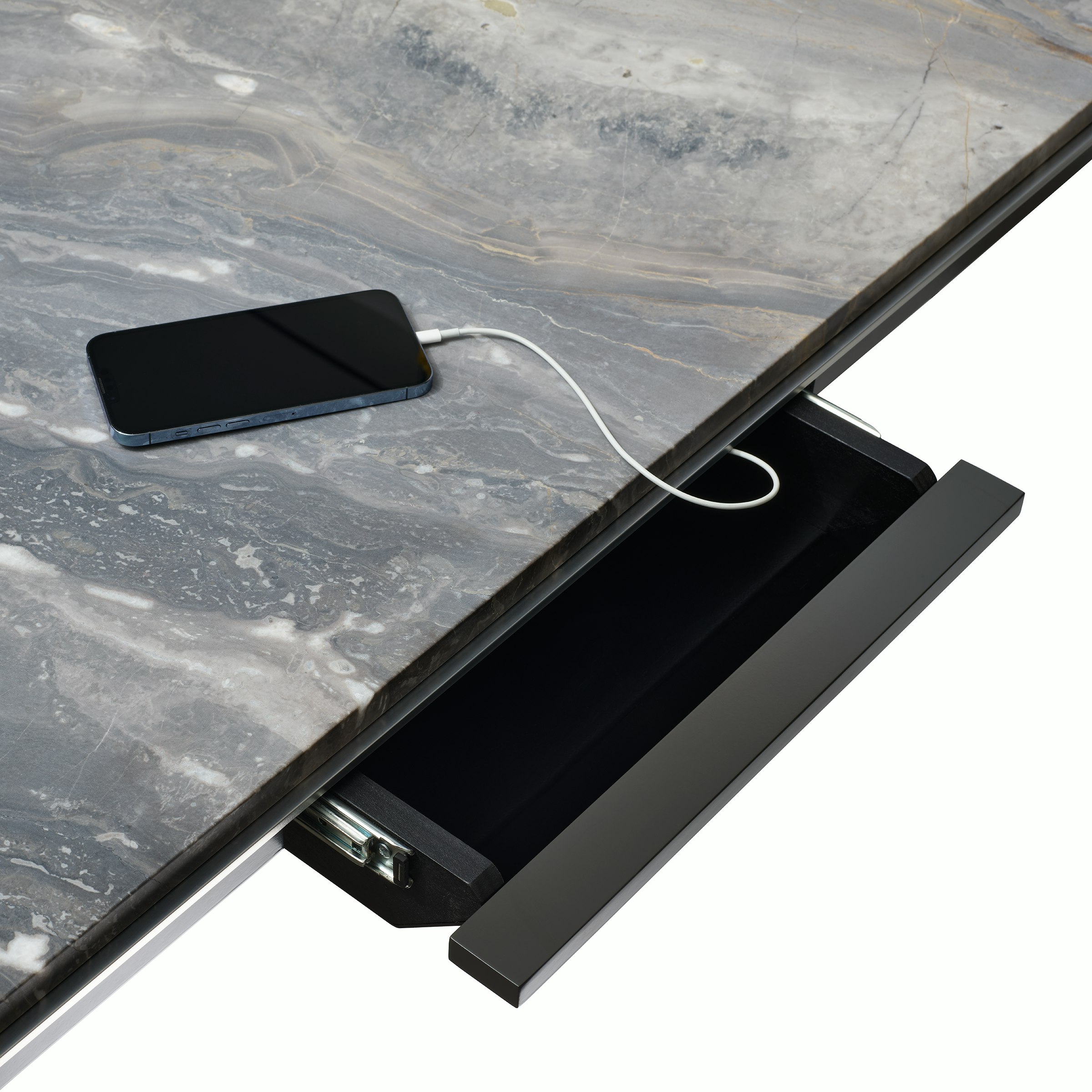 Detail view of open power drawer charging an iPhone on a Highline Conference Table with a Marble top and polished chrome edge.