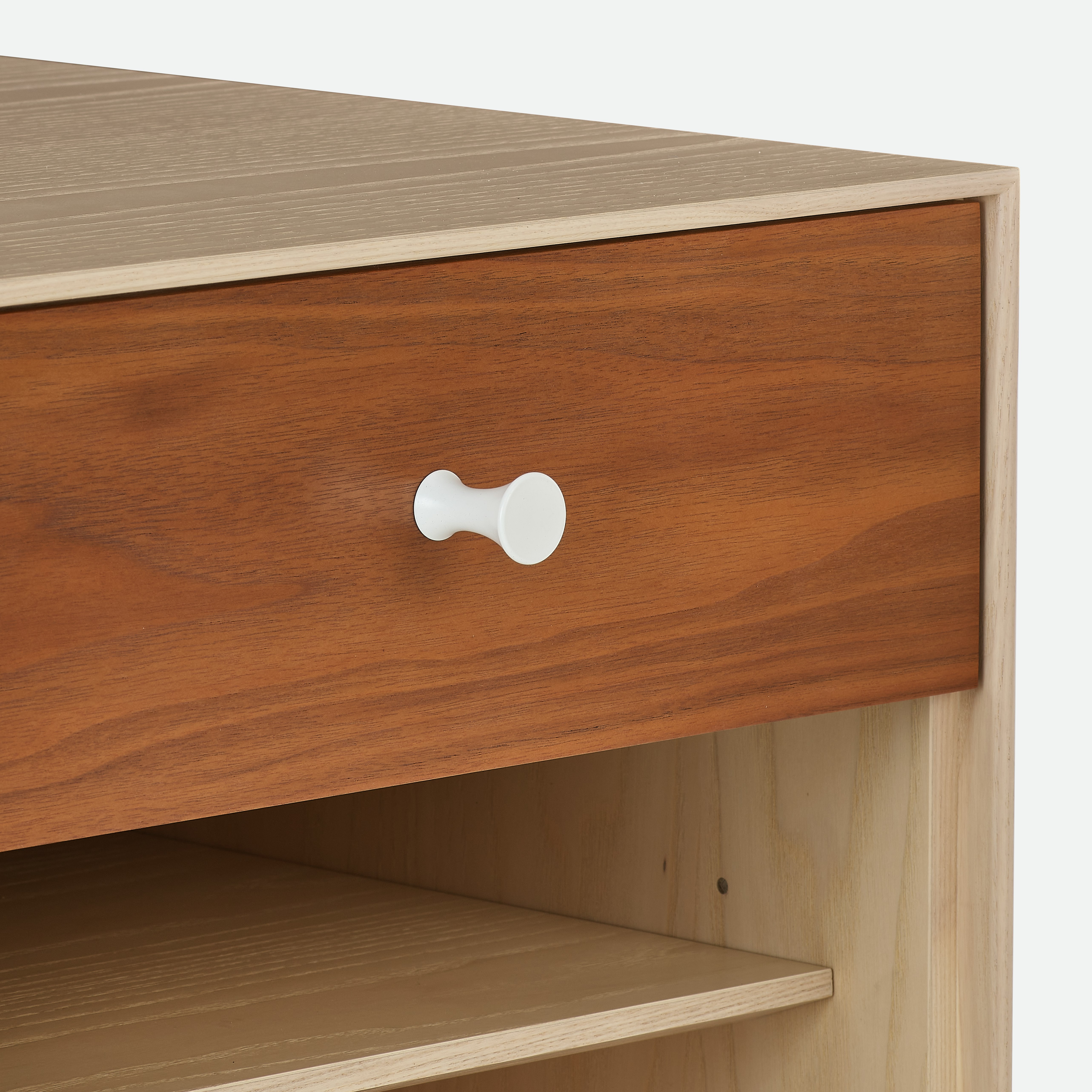 A detailed view of a Nelson Thin Edge Bedside Table in walnut white.