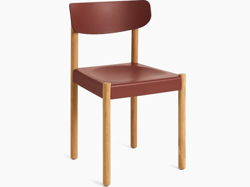 Pack Side Chair with red seat and back on oak legs, angled view