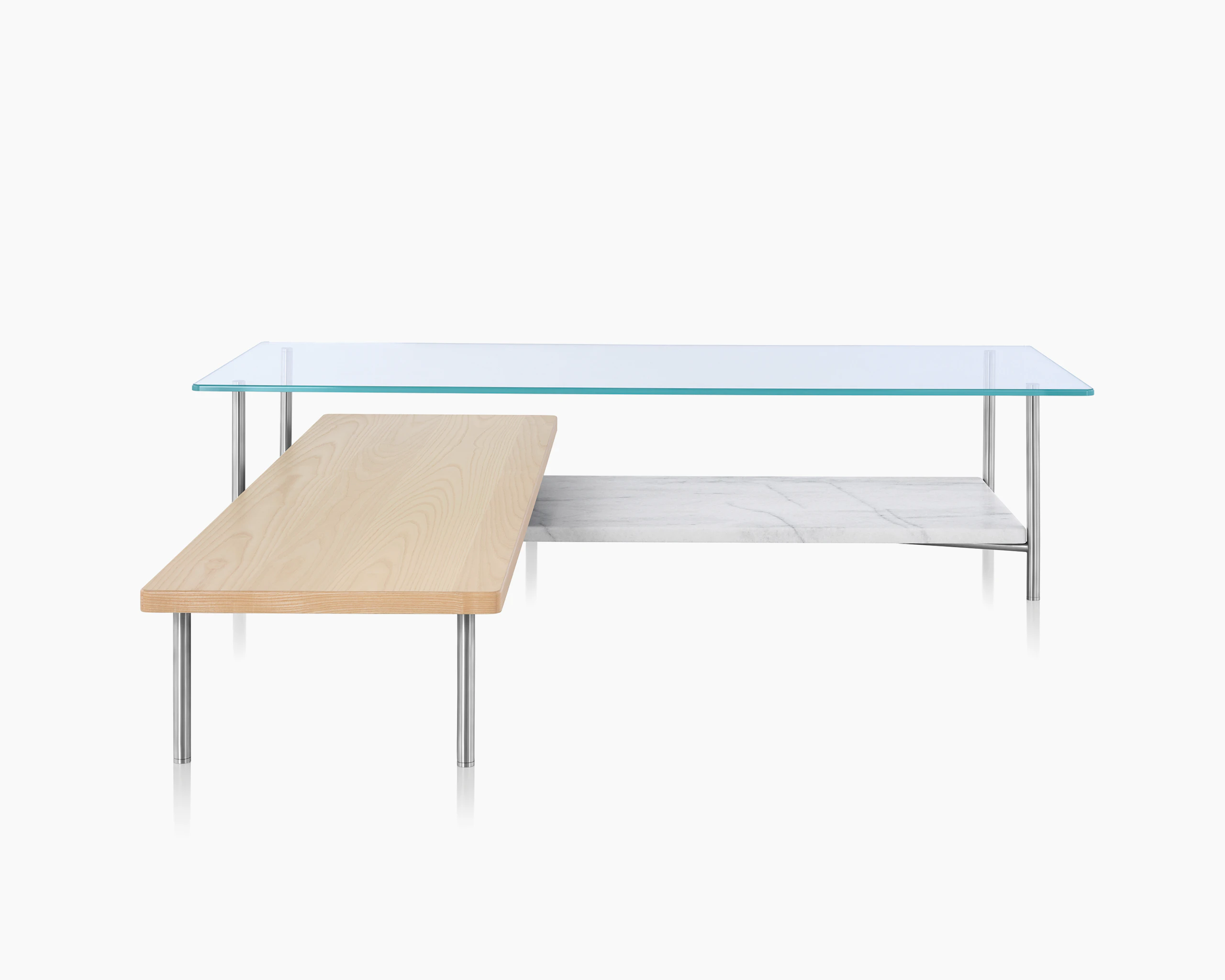 An L-shaped Layer coffee table with a glass top, marble lower shelf, and intersecting wood shelf with a light finish.