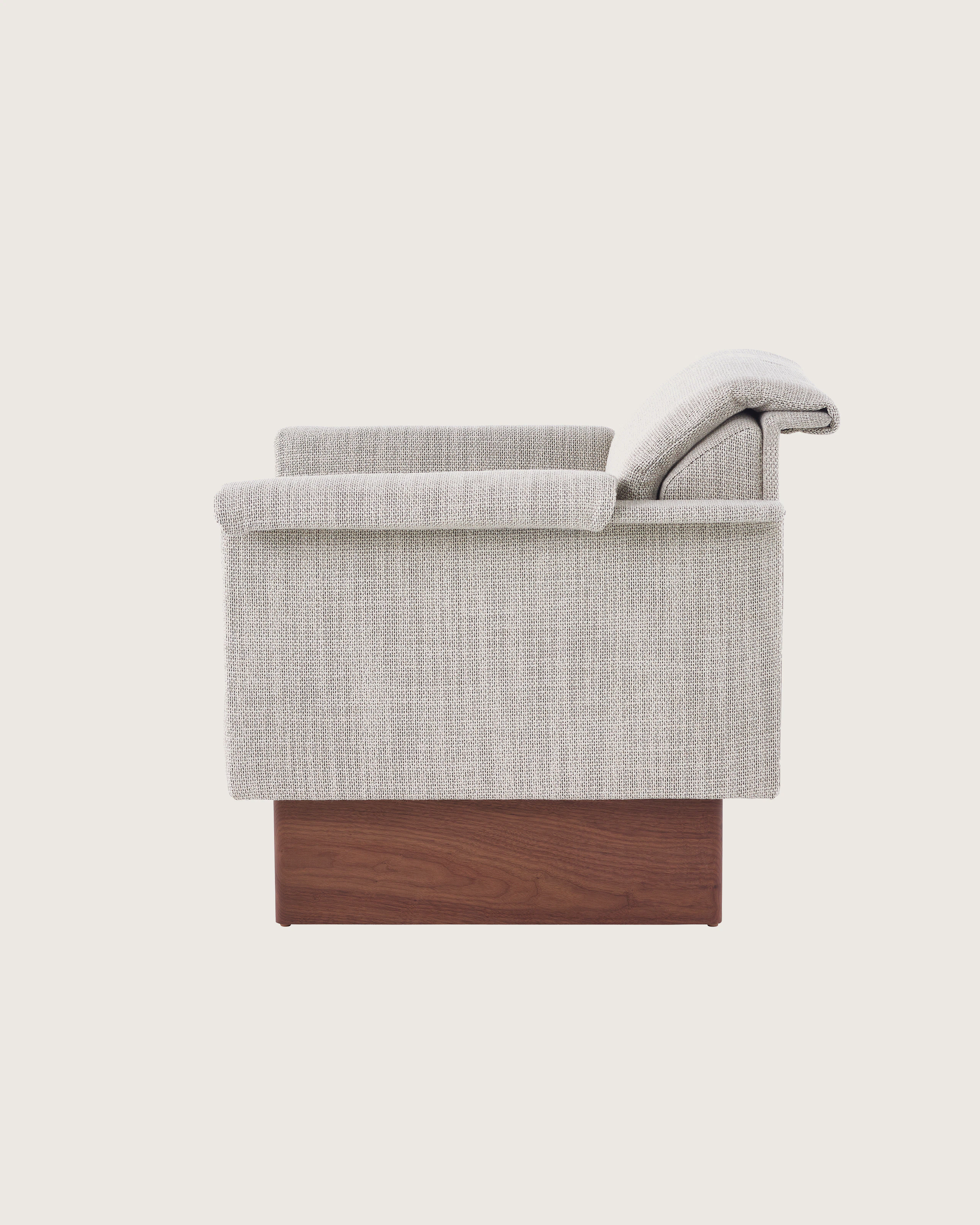 Mantle Club Chair in Capri Stone with Walnut Wood Base, side view.