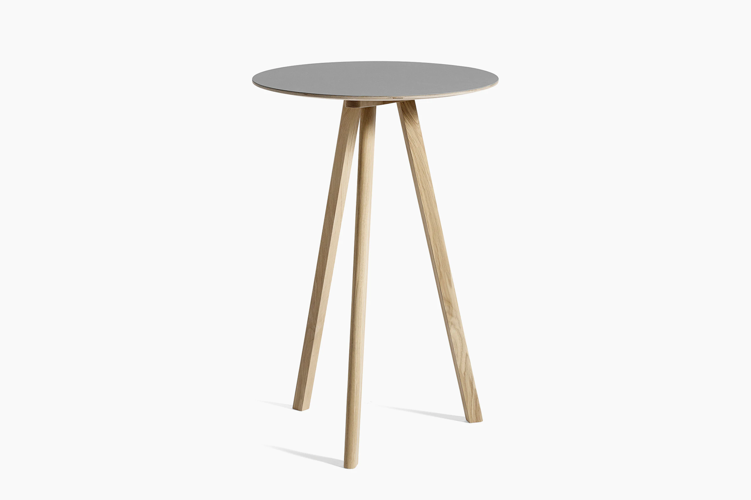 Grey Copenhague Bistro Table with wooden legs, viewed at an angle.