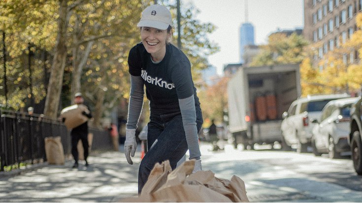 A smiling MillerKnoll associate volunteering in New York City during MillerKnoll Day of Purpose 2025.