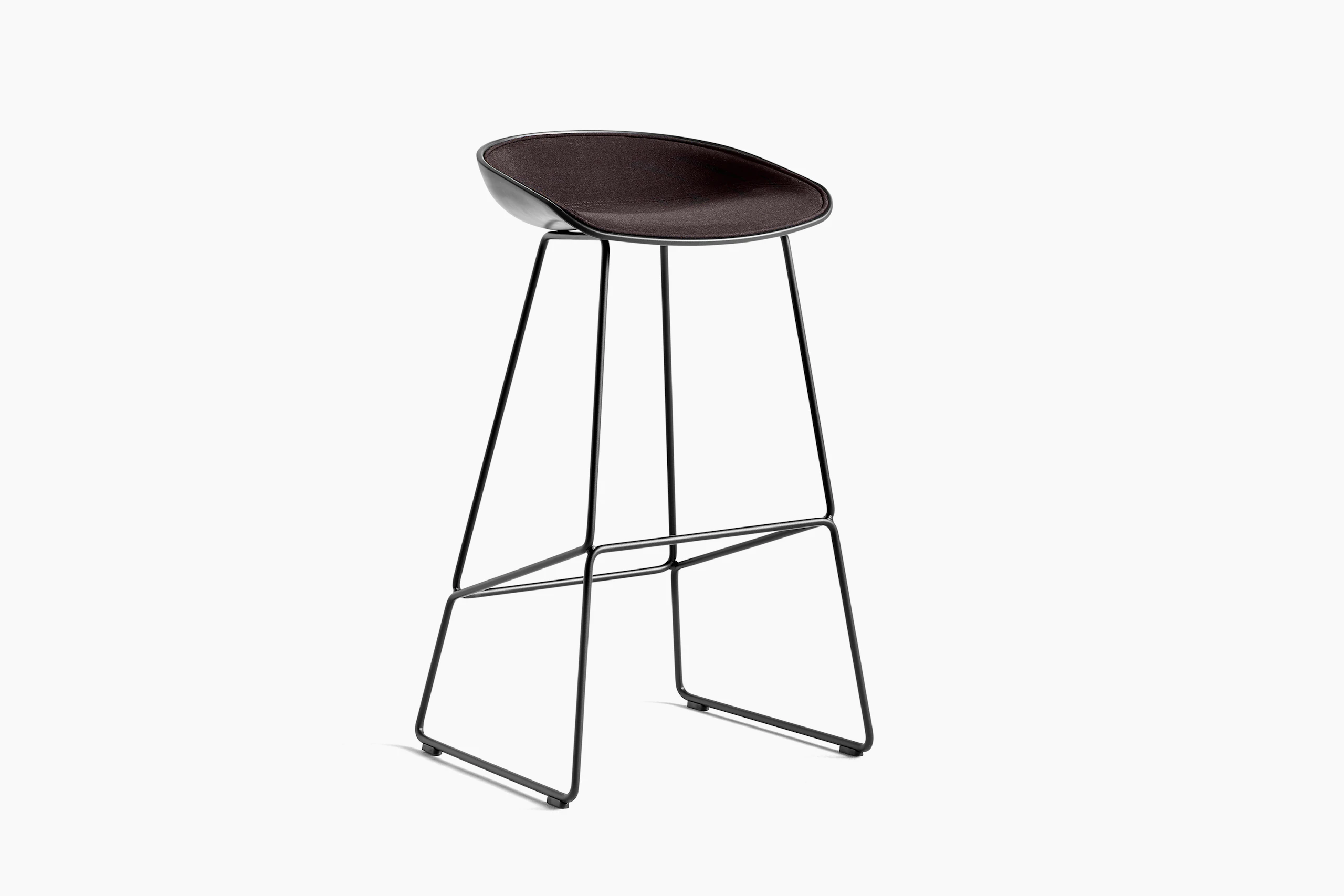 Black upholstered About A Stool with wooden base, viewed at an angle.