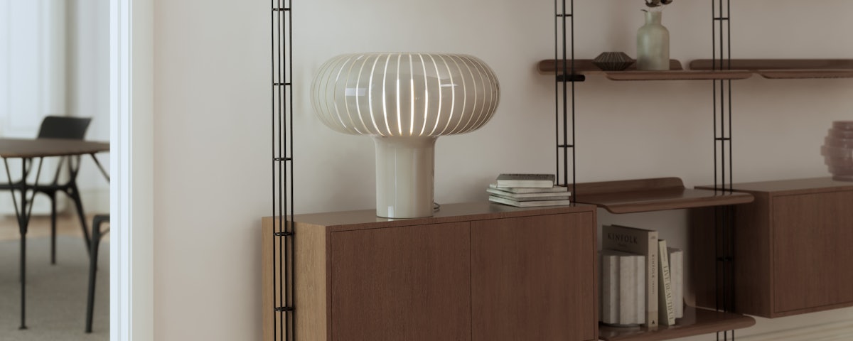 Teresa Table Lamp on a wall bookshelf in a living room setting