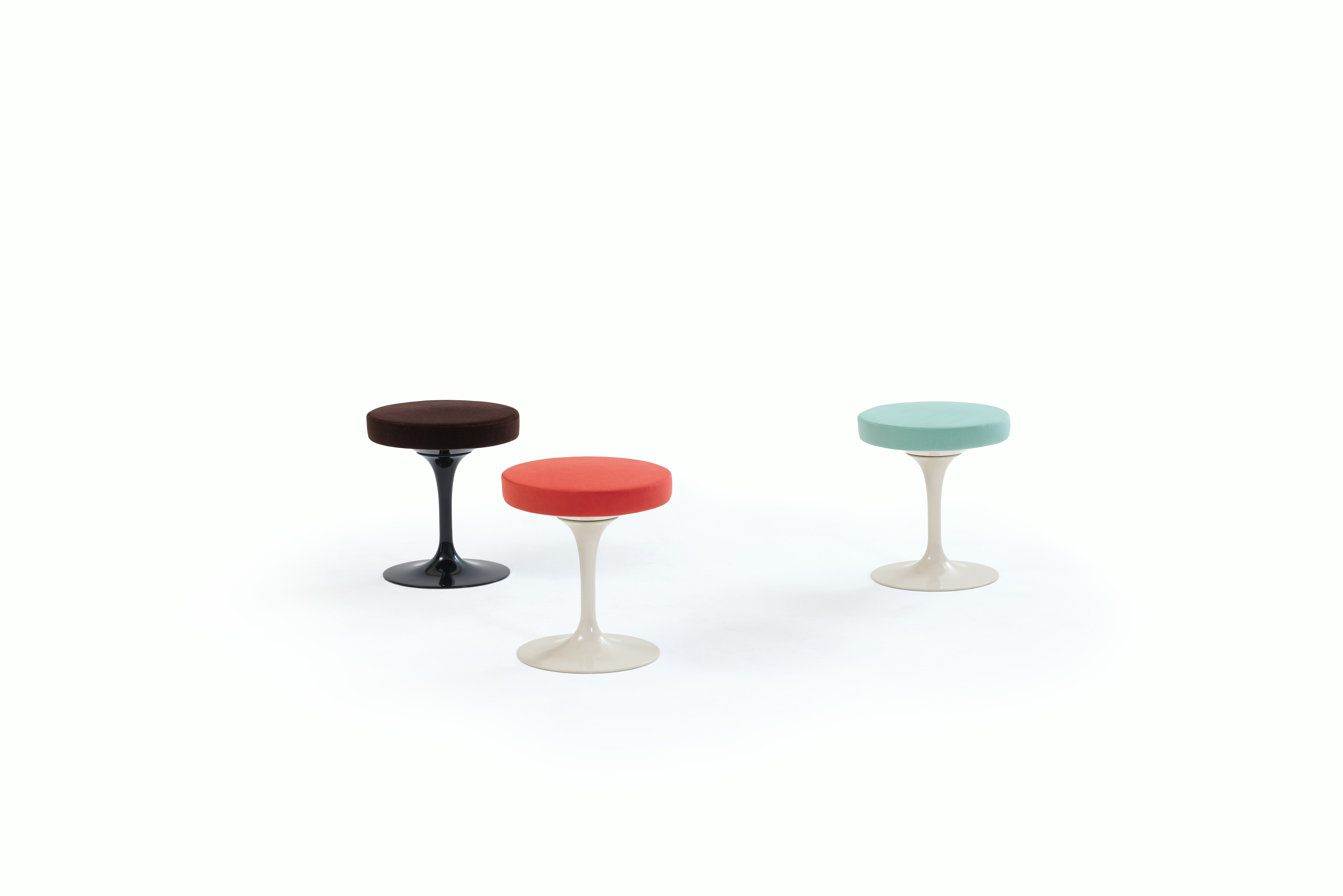 Three Tulip Stools with black, red, and blue seats.