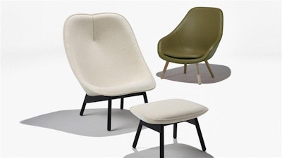 A green chair and a white chair and ottoman on a white background