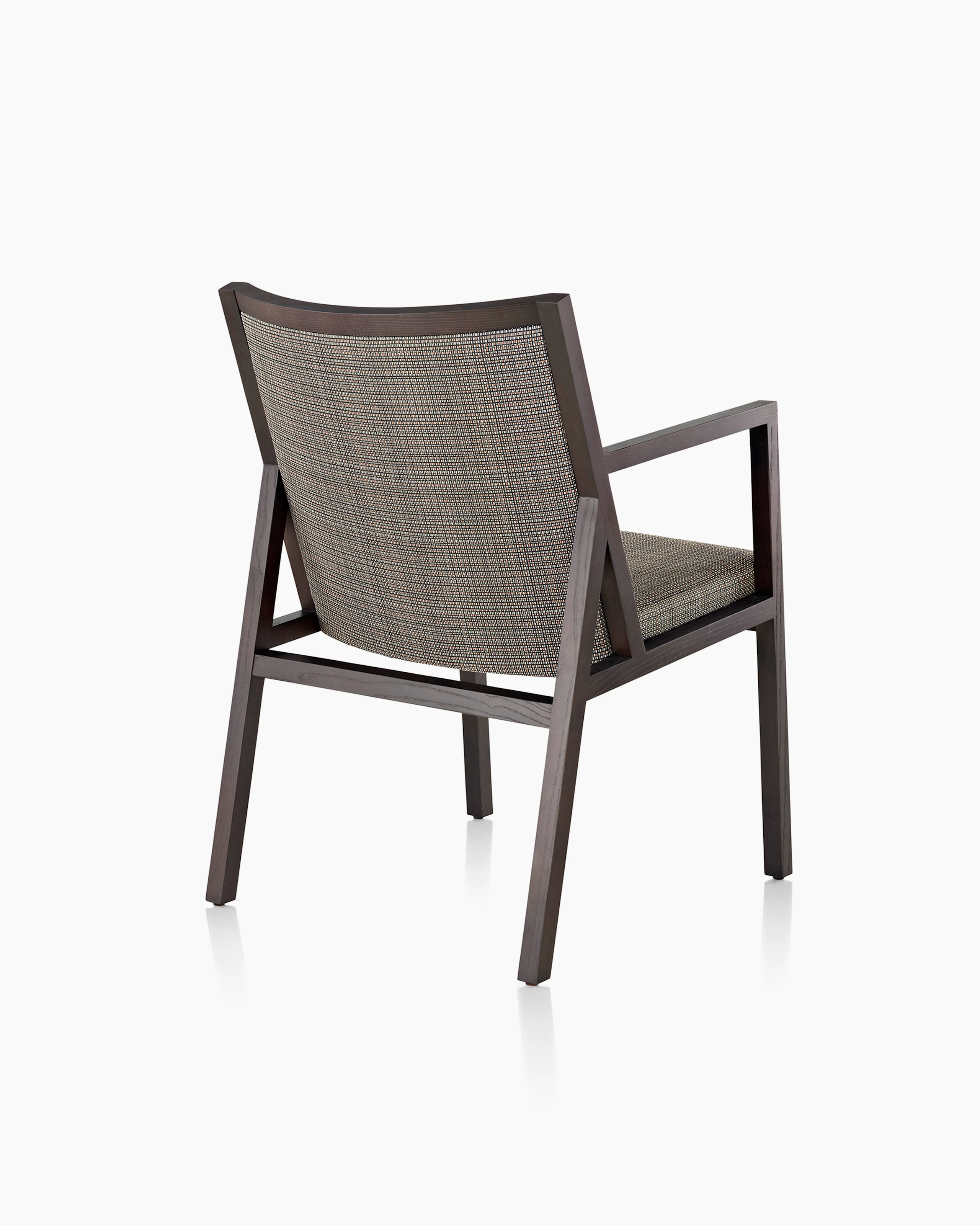 An Ascribe side chair with gray Tattersall Reverse upholstery and a wood frame with a dark finish, viewed from behind at an angle.