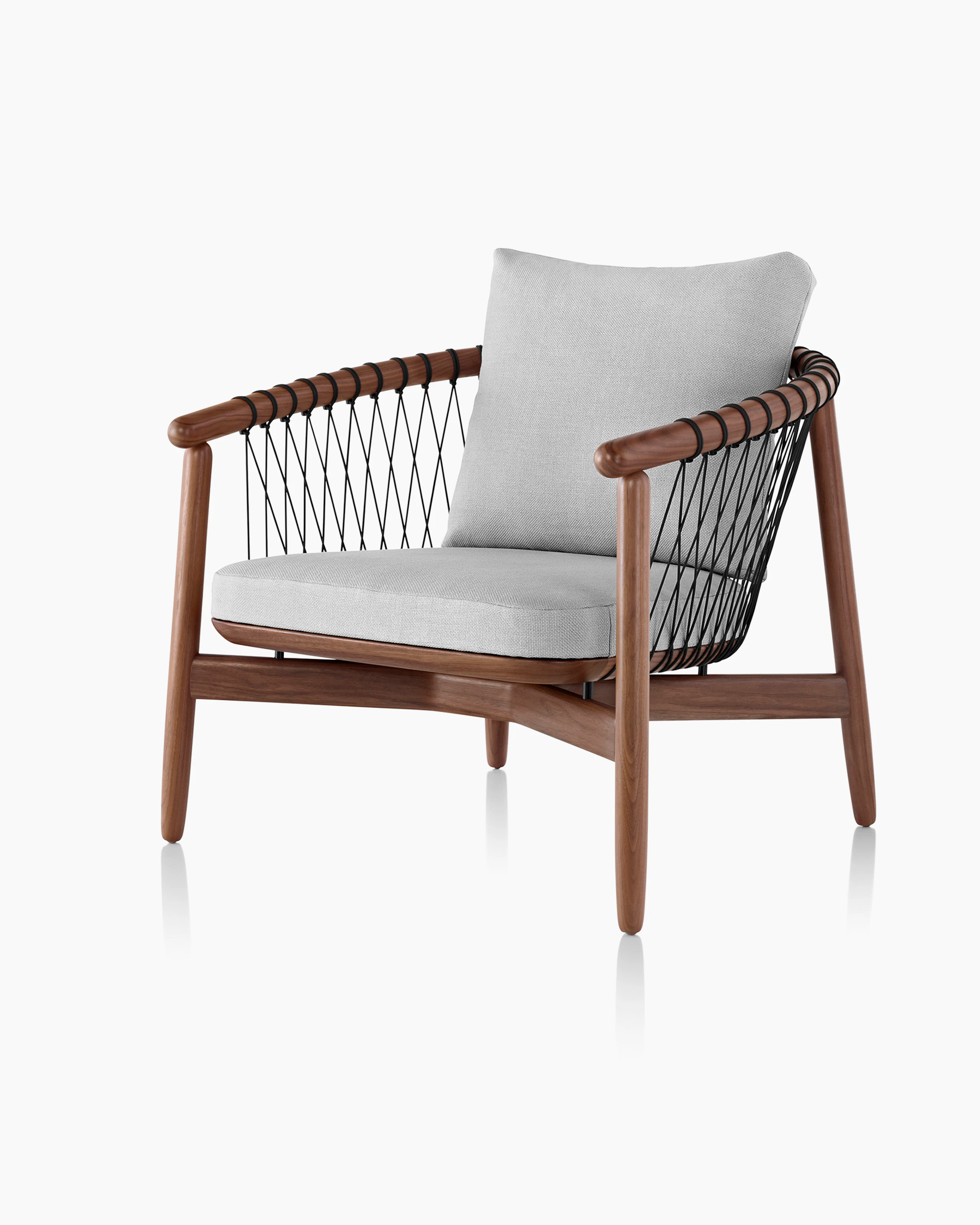Angled view of a Crosshatch lounge chair with light gray fabric and a wood frame in a medium finish.