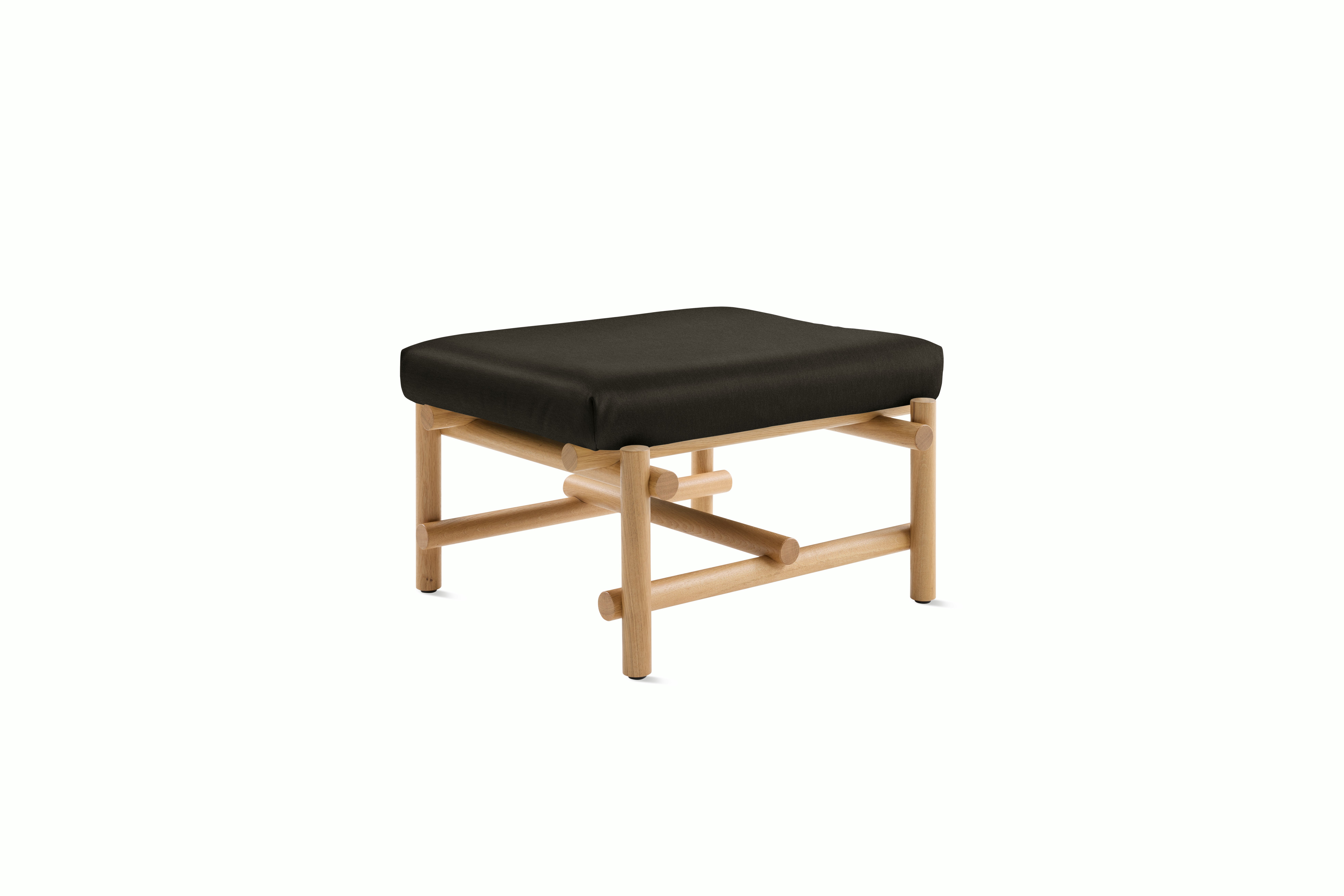 A Muecke Ottoman in Truffle White Oak viewed from an angle.