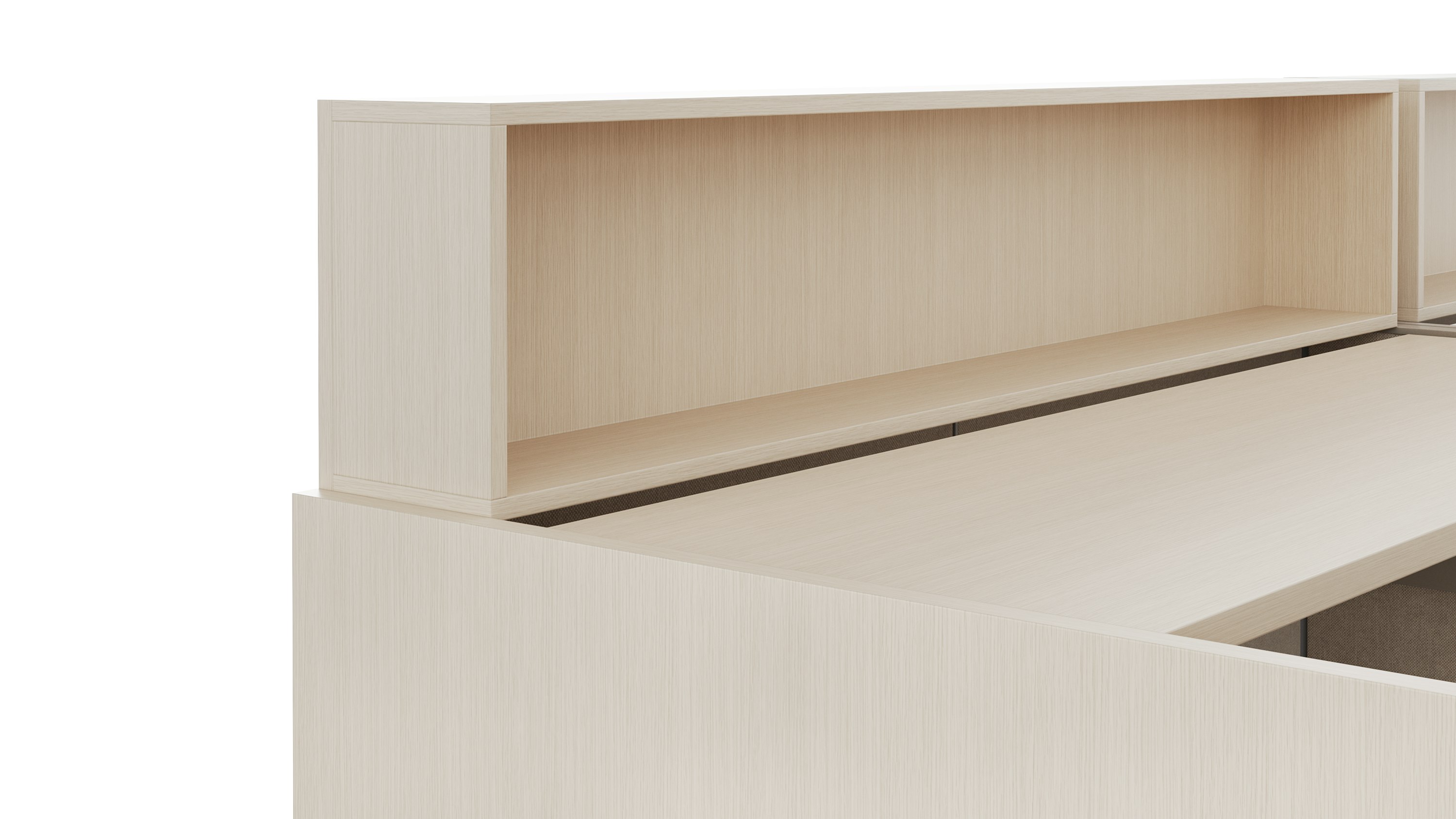 A height adjustable work surface is viewed from an angle. On top of the work surface is a personal storage cubby in a light color veneer.