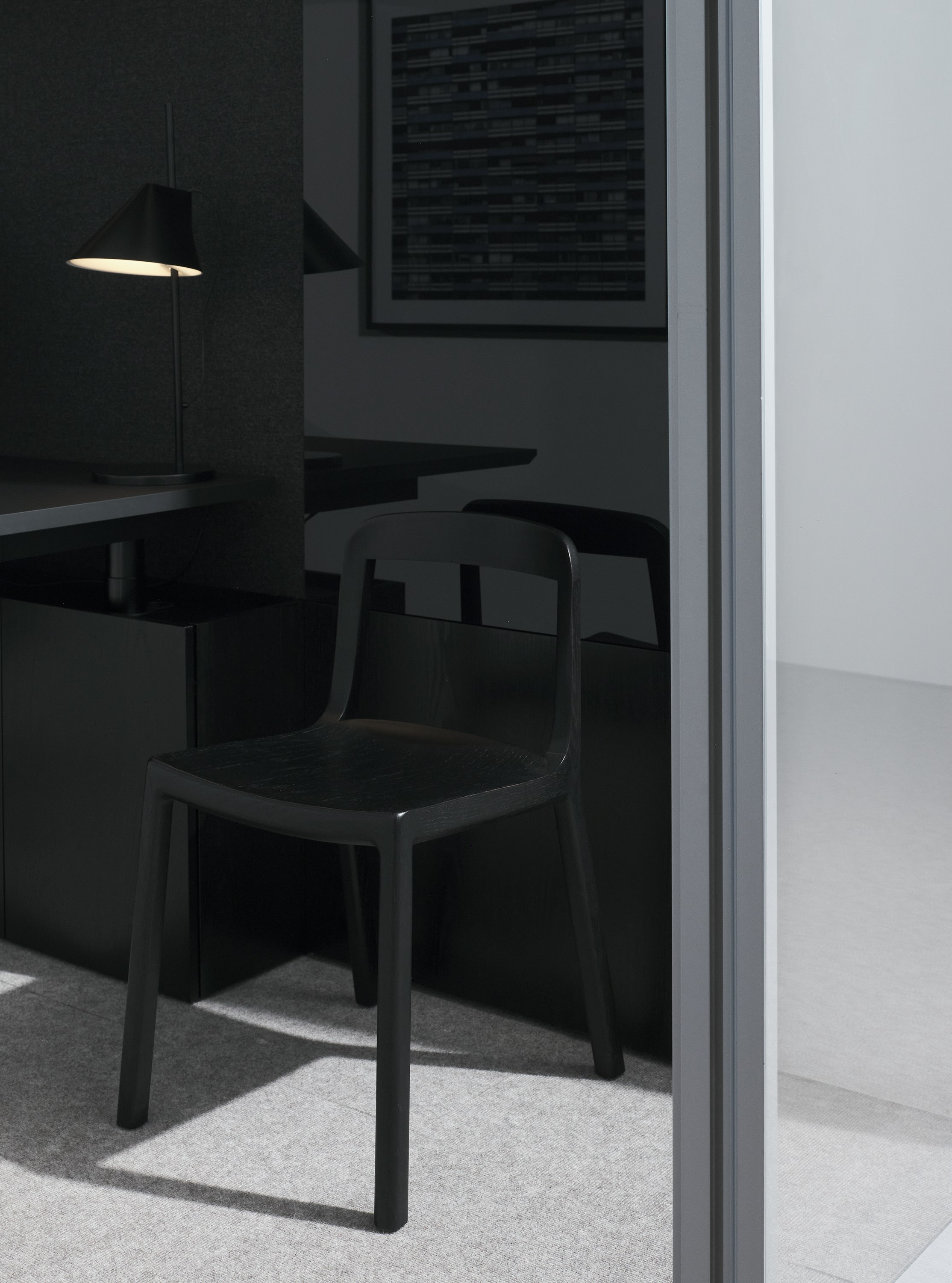 Lijn Side Chair in Ebonized Oak with an open back and wood seat in a private office setting, viewed at an angle.