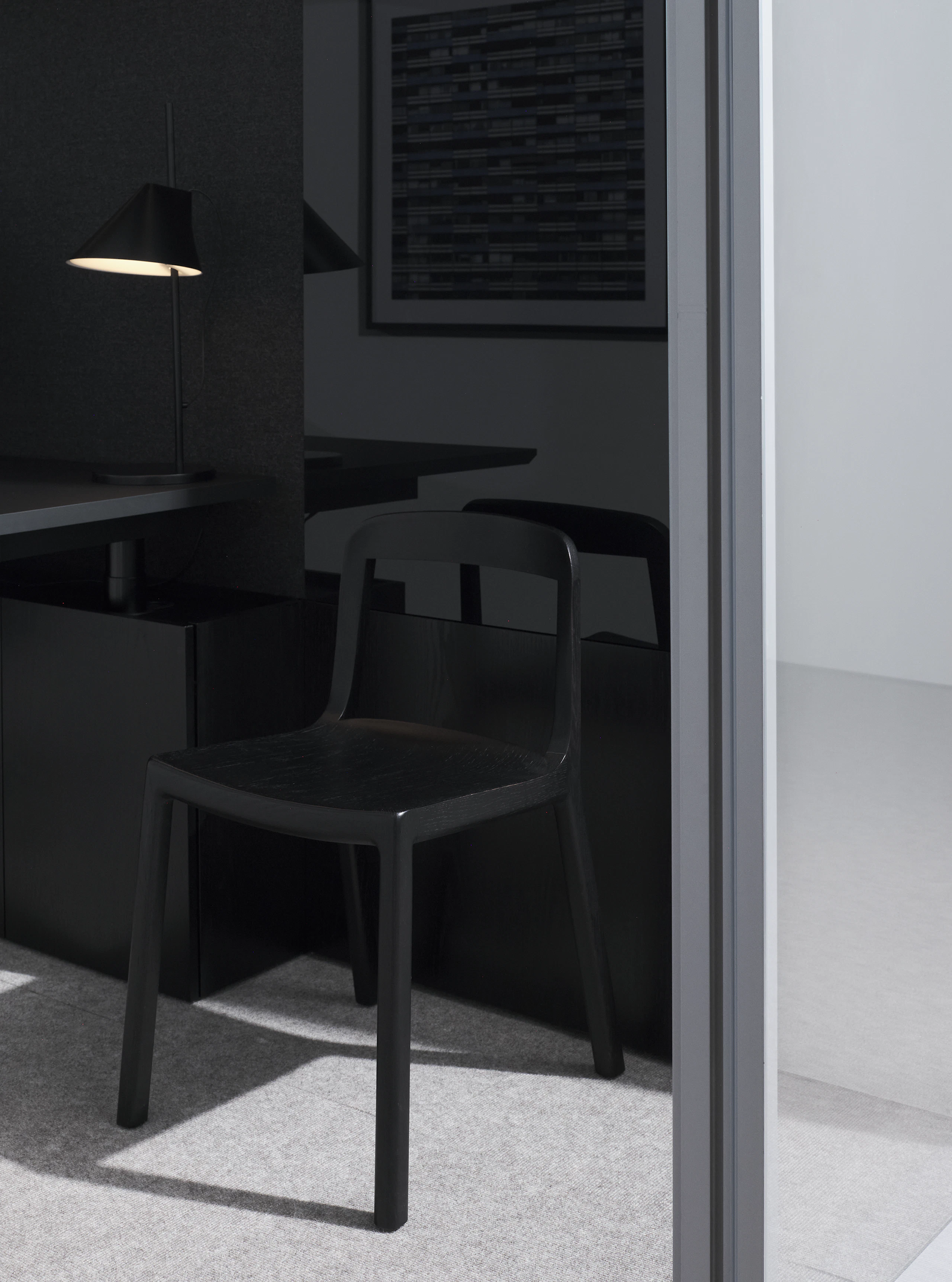 Lijn Side Chair in Ebonized Oak with an open back and wood seat in a private office setting, viewed at an angle.