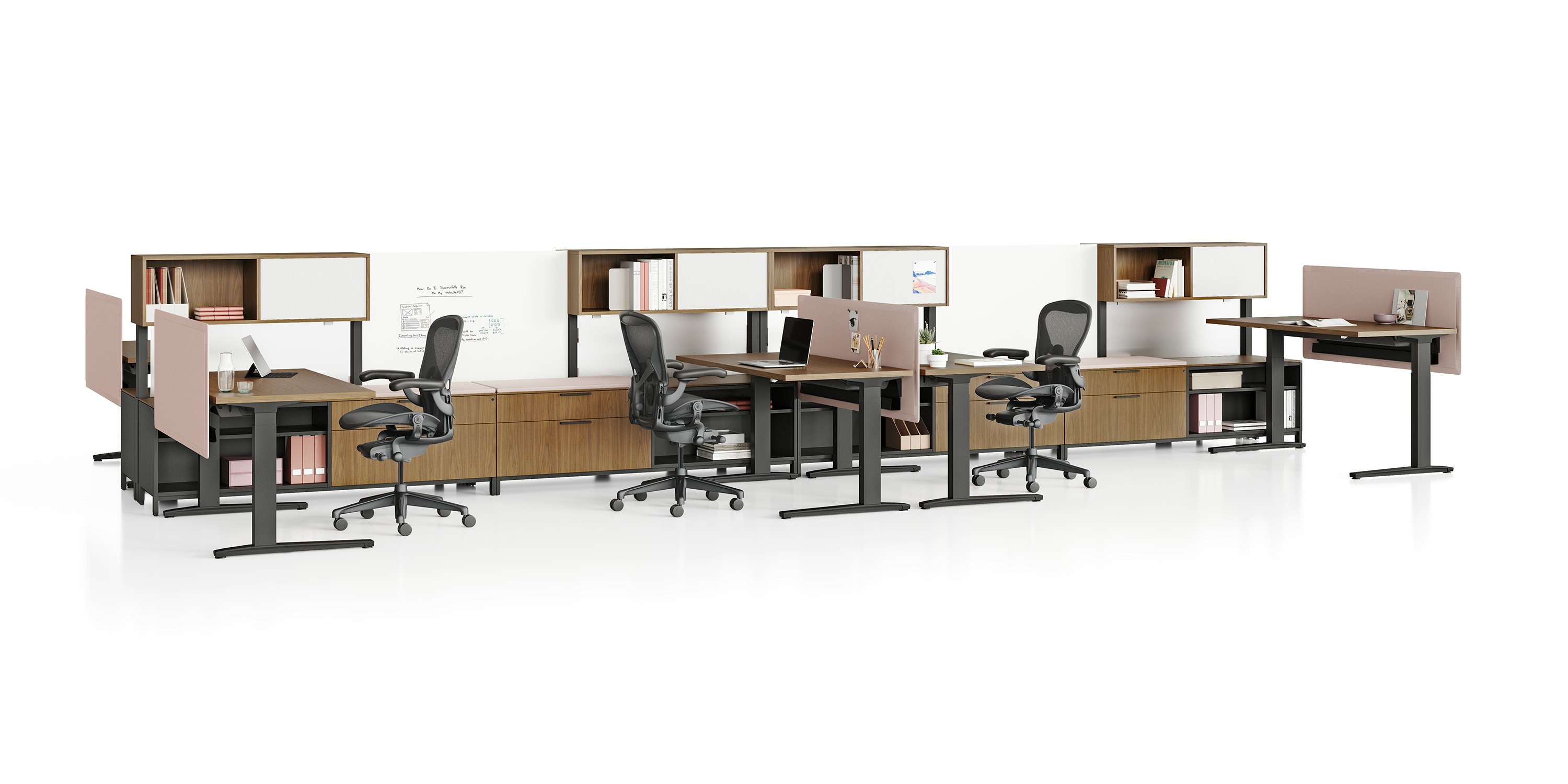 Canvas Dock workstations with sit-to-stand tables, storage, pink screens, and black Aeron Chairs.