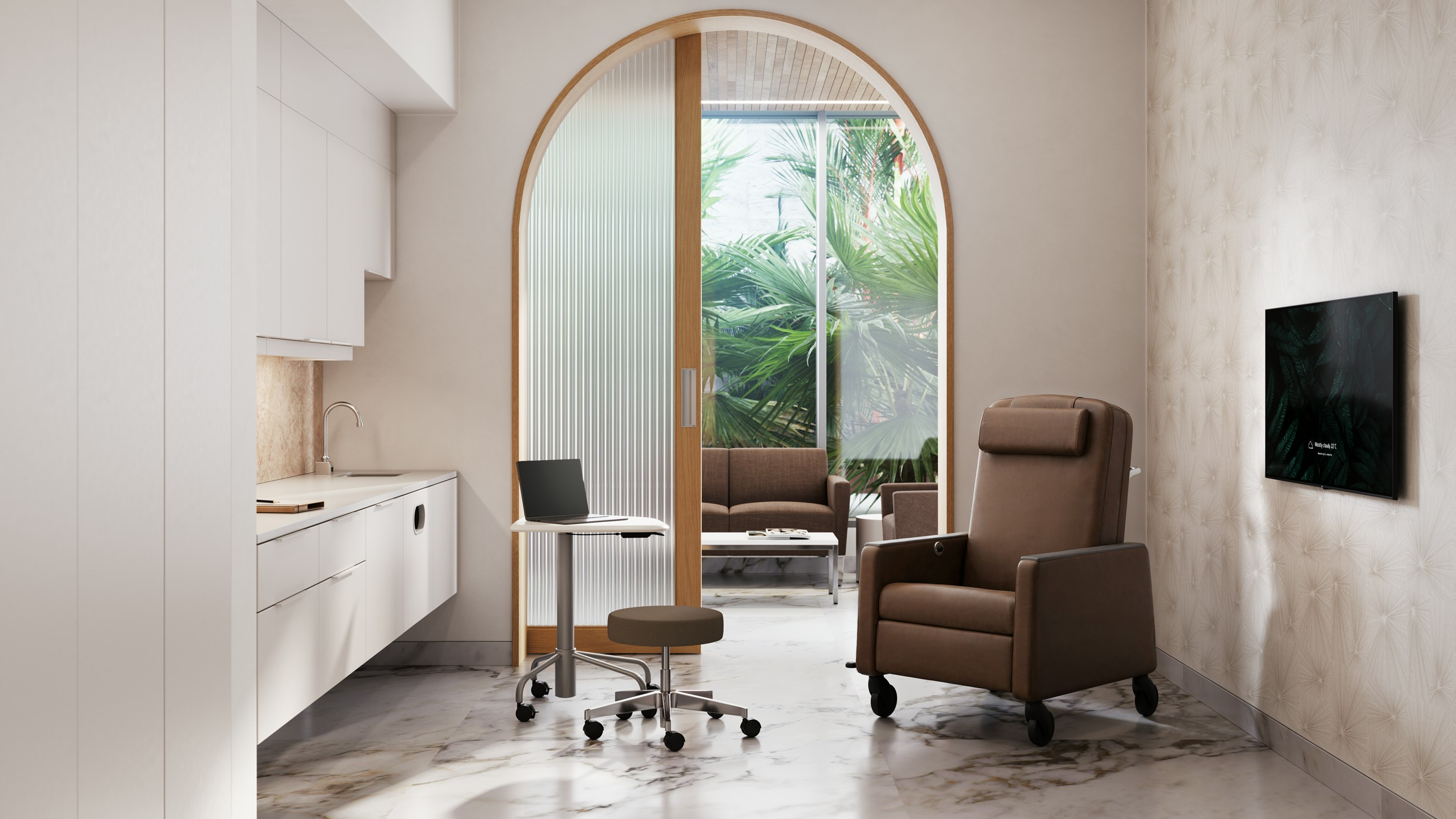 Exam room furnished with a Herman Miller Gemma Recliner, small rolling stool and worktable, and a large white Compass System with built in sink.