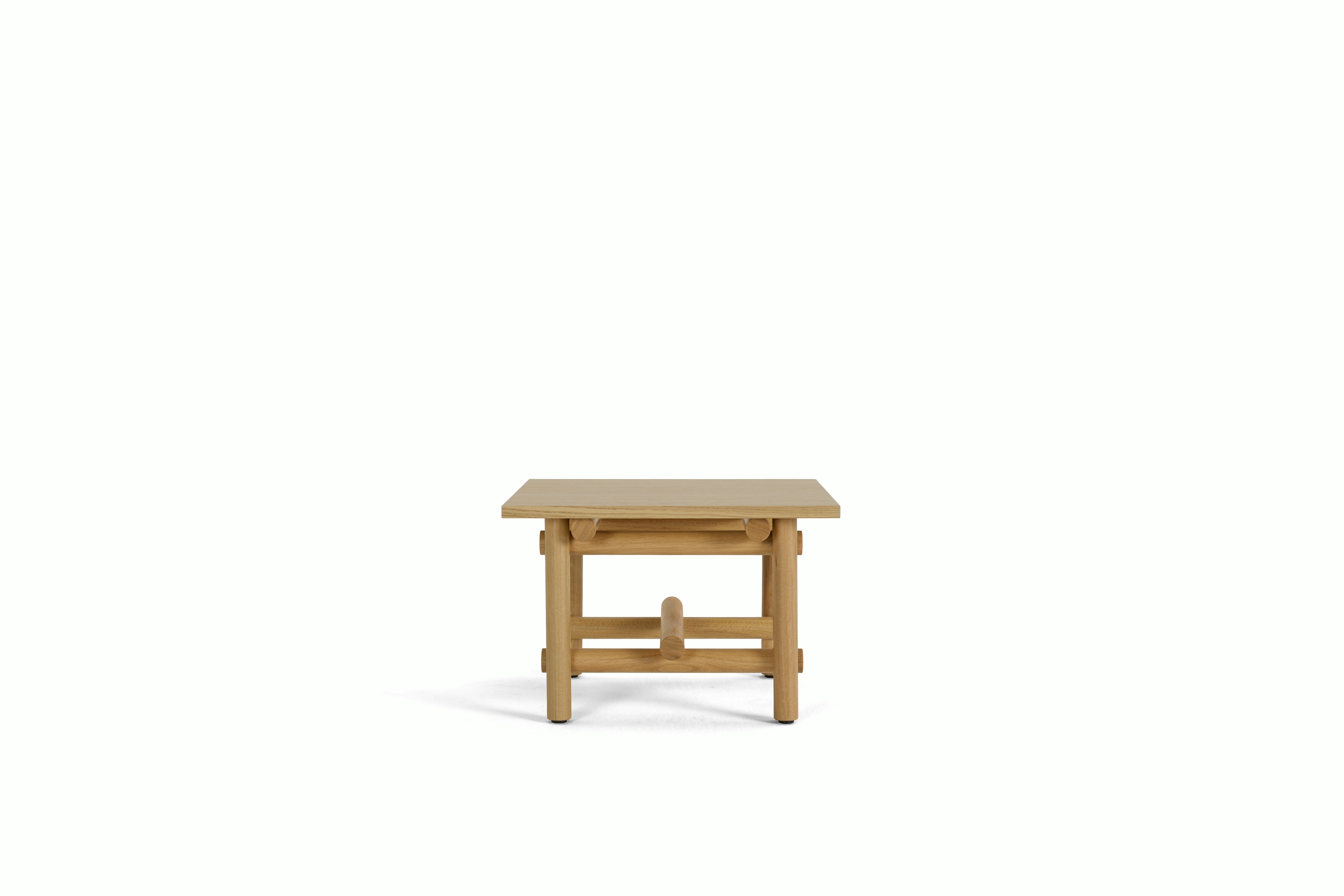 A Muecke Side Table in White Oak viewed from the side.