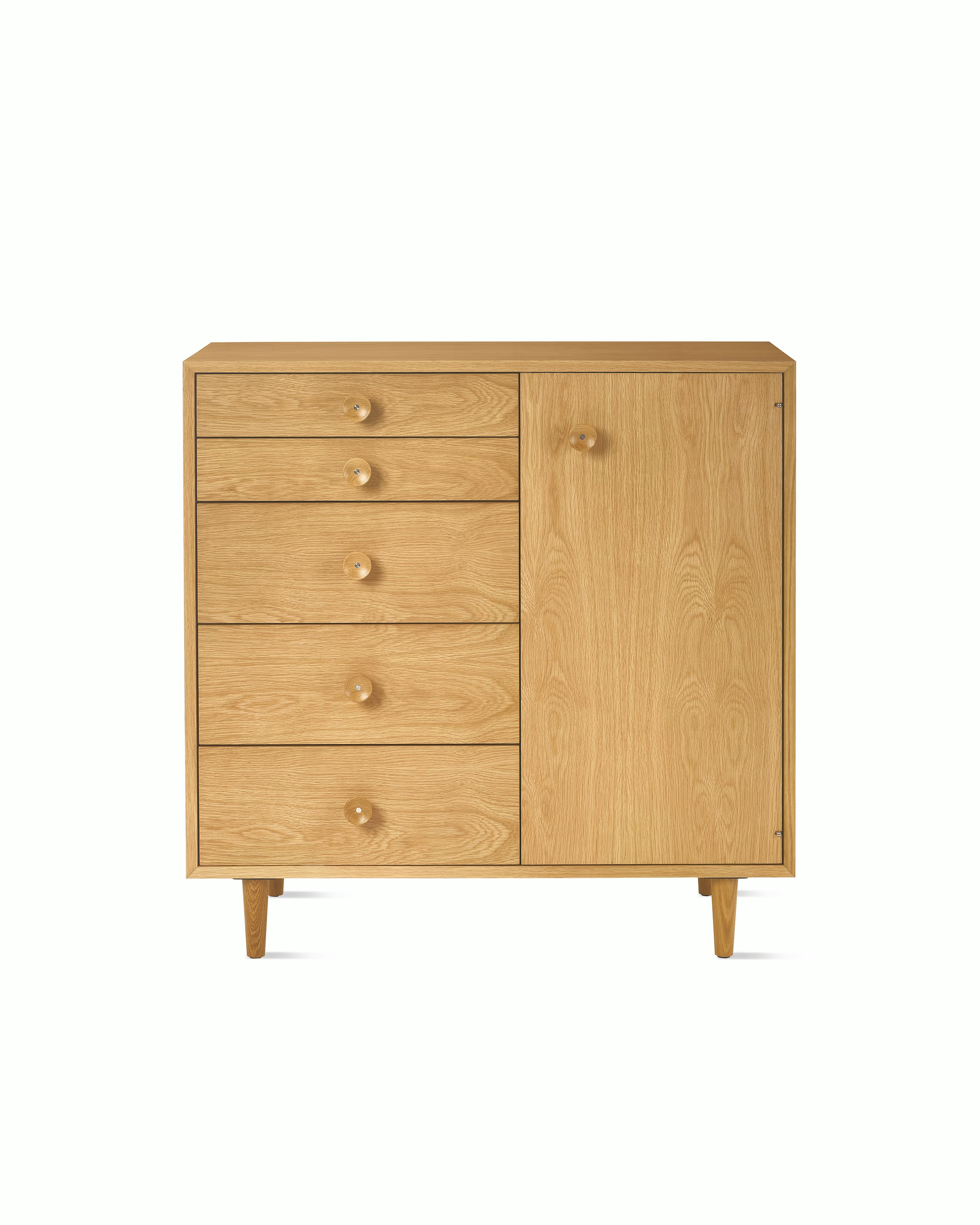 Nelson Basic Cabinet Series 5 drawers, one door, taper legs, cupcake pulls, in natural oak.