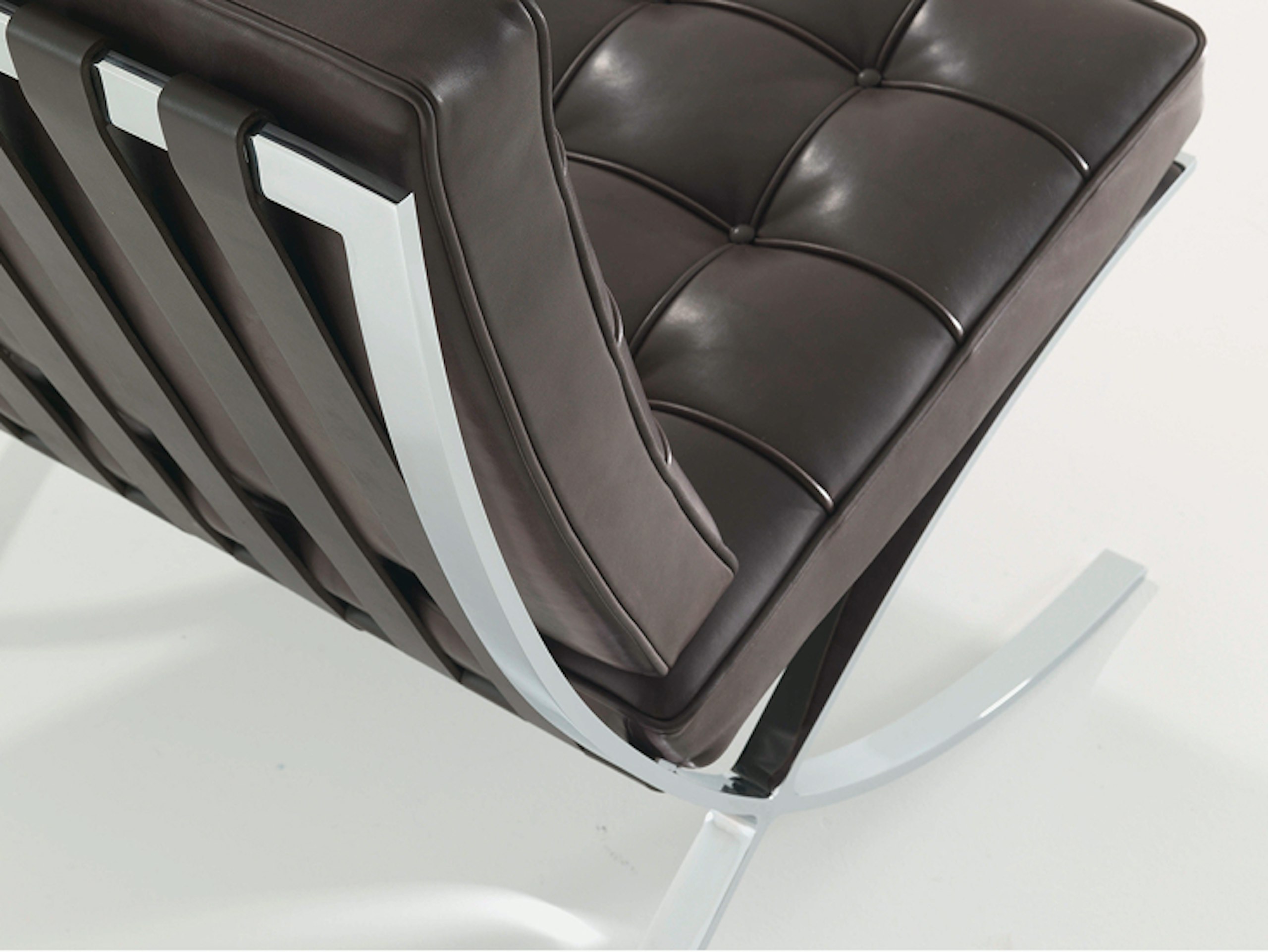 A black Barcelona Chair by Knoll viewed from the back at an angle