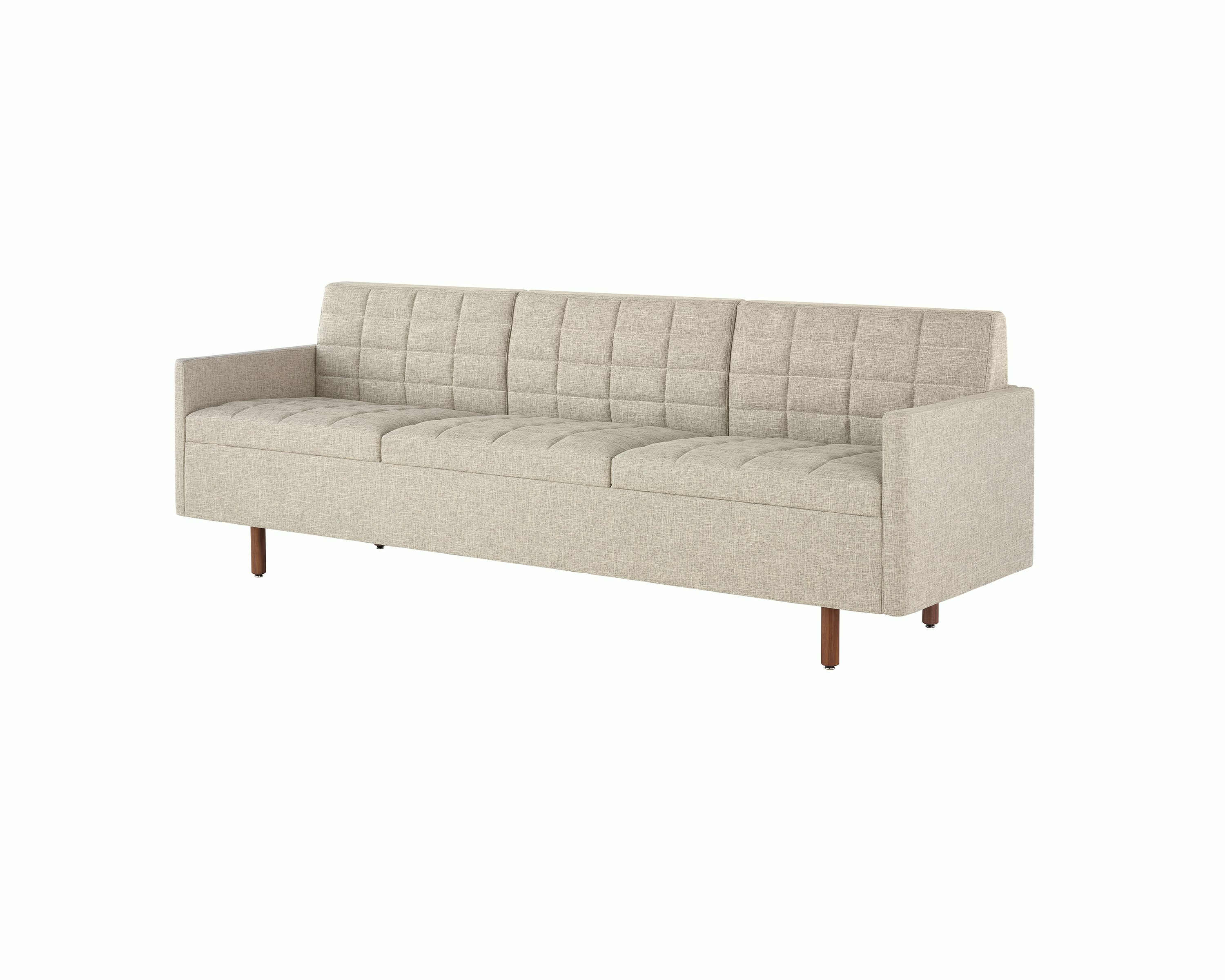 A Tuxedo Classic sofa with bone-colored quilted upholstery, viewed at an angle.
