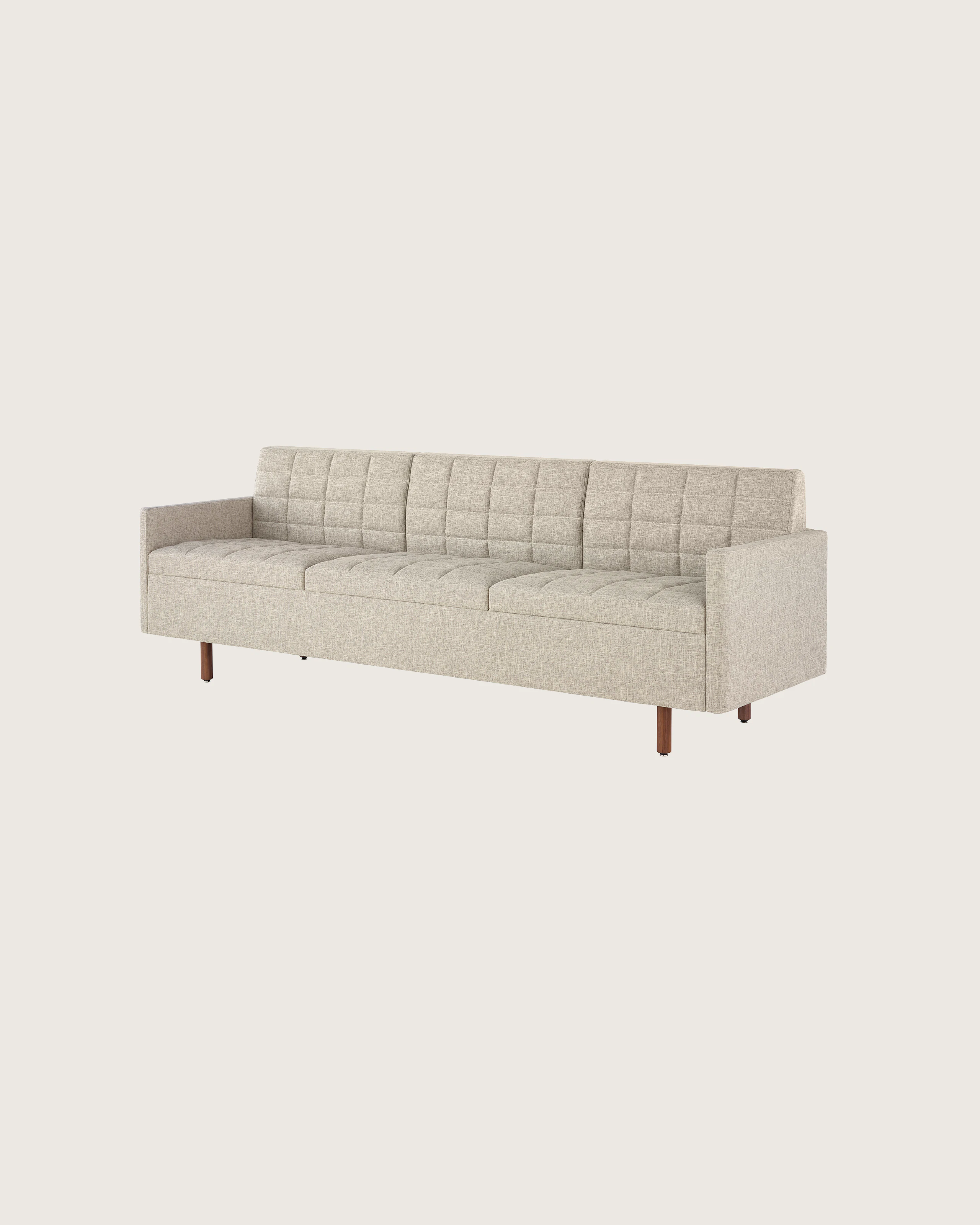 A Tuxedo Classic sofa with bone-colored quilted upholstery, viewed at an angle.