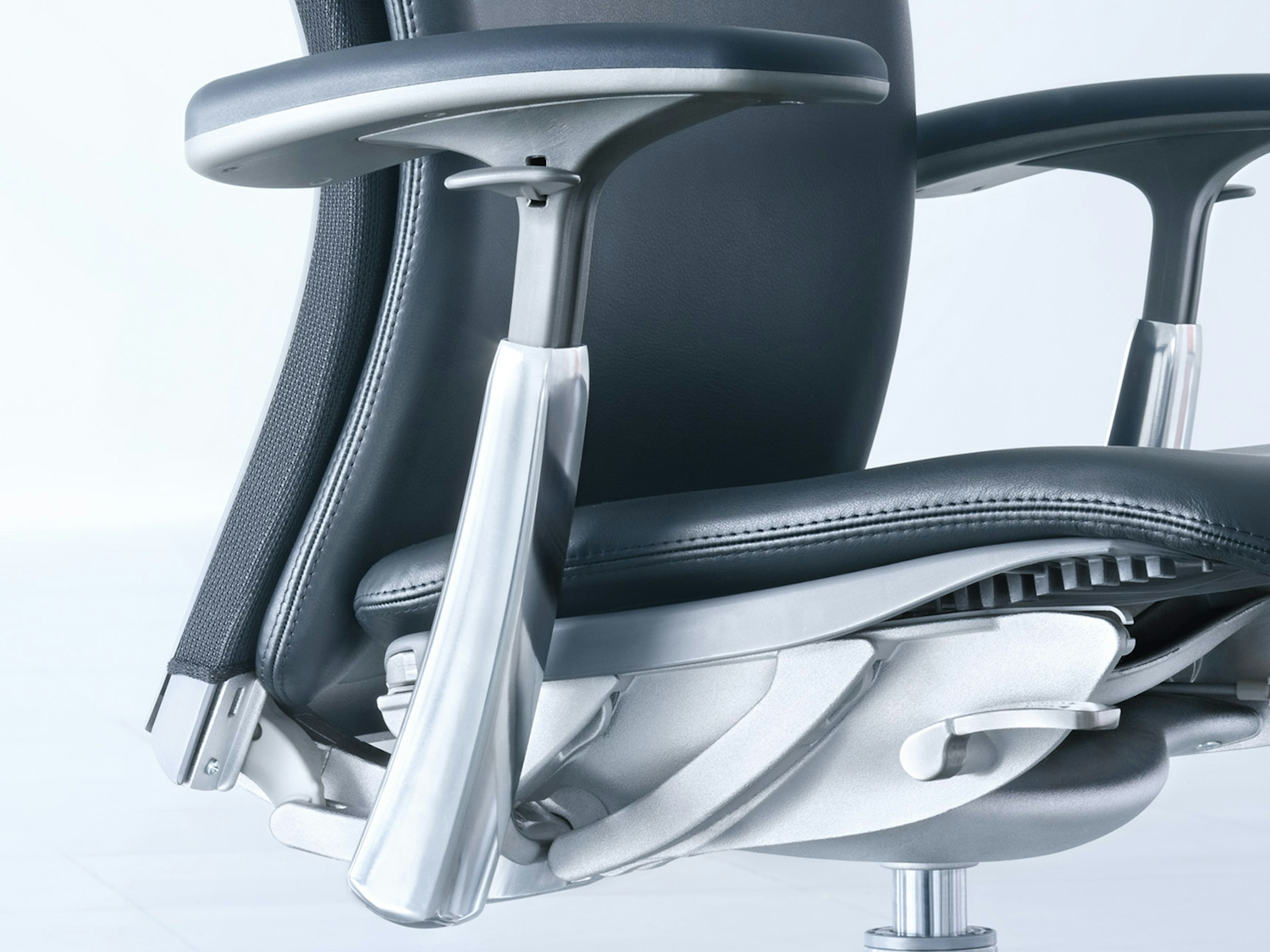 A 3/4 front view of a Knoll Life Chair with a black leather seat and silver frame