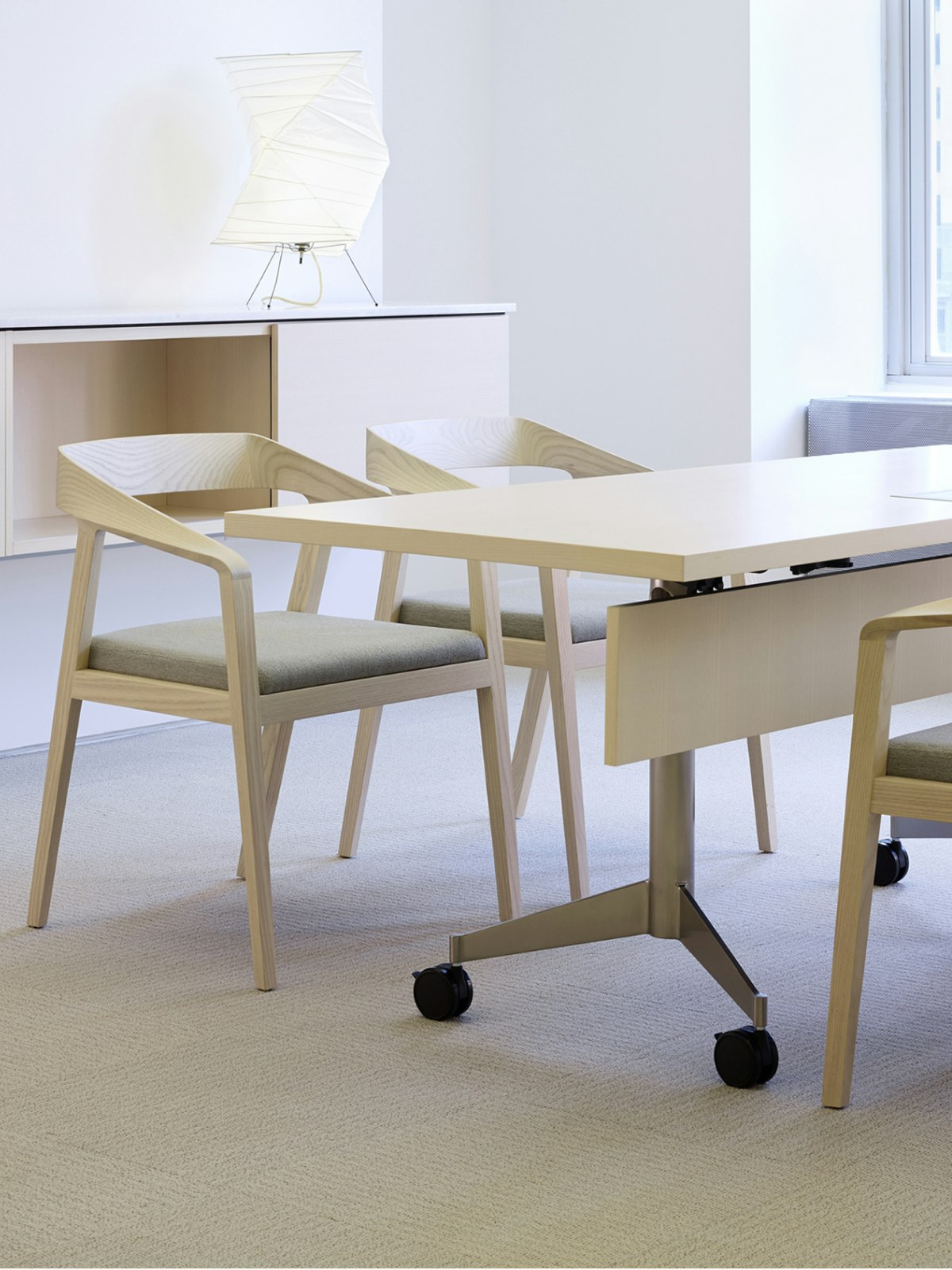 A MP Flex Table with four Full Twist Guest Chairs with seats upholstered in a Epingle textile.