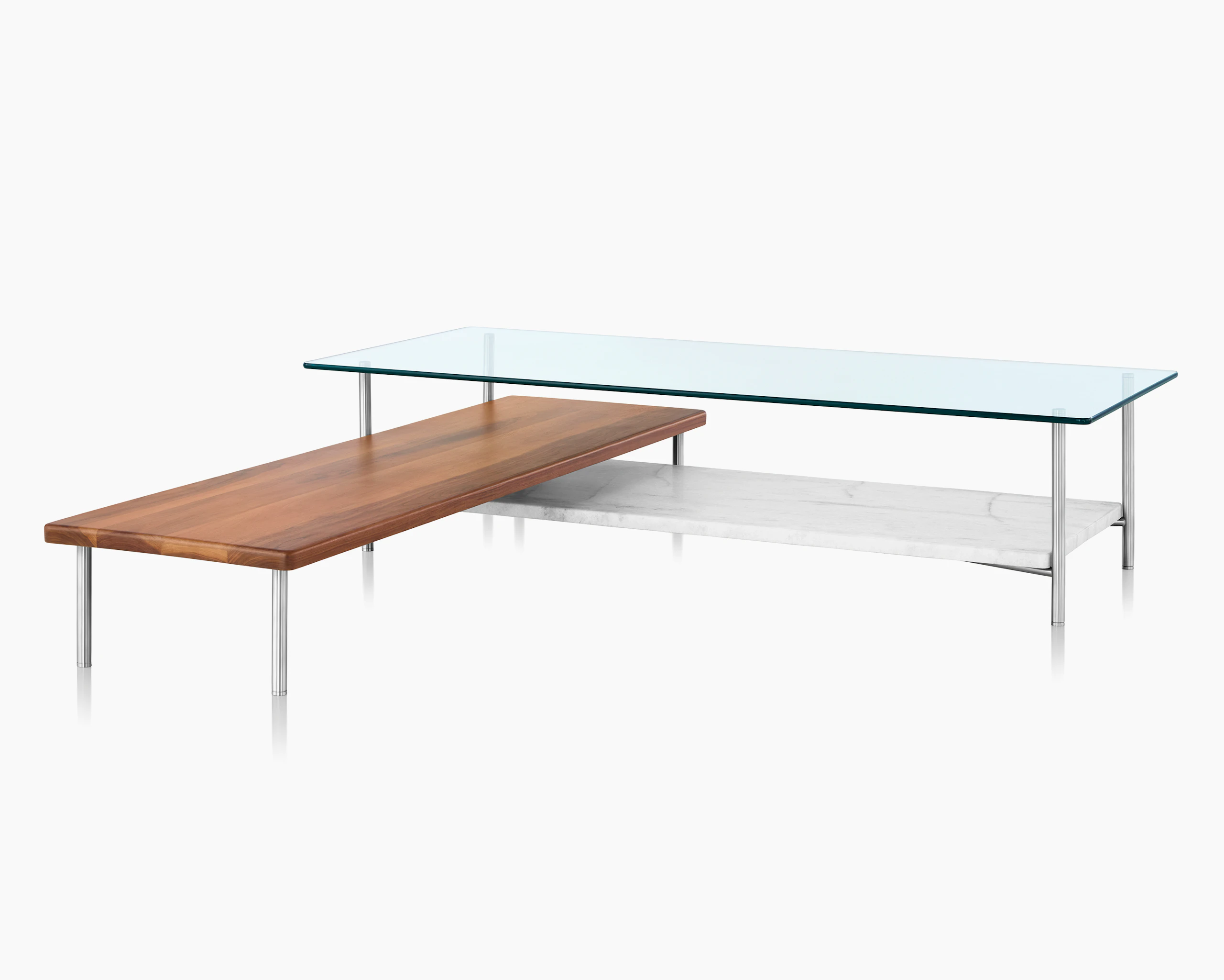 Partial view of an L-shaped Layer coffee table, focusing on the soft corners and cylindrical metal legs.