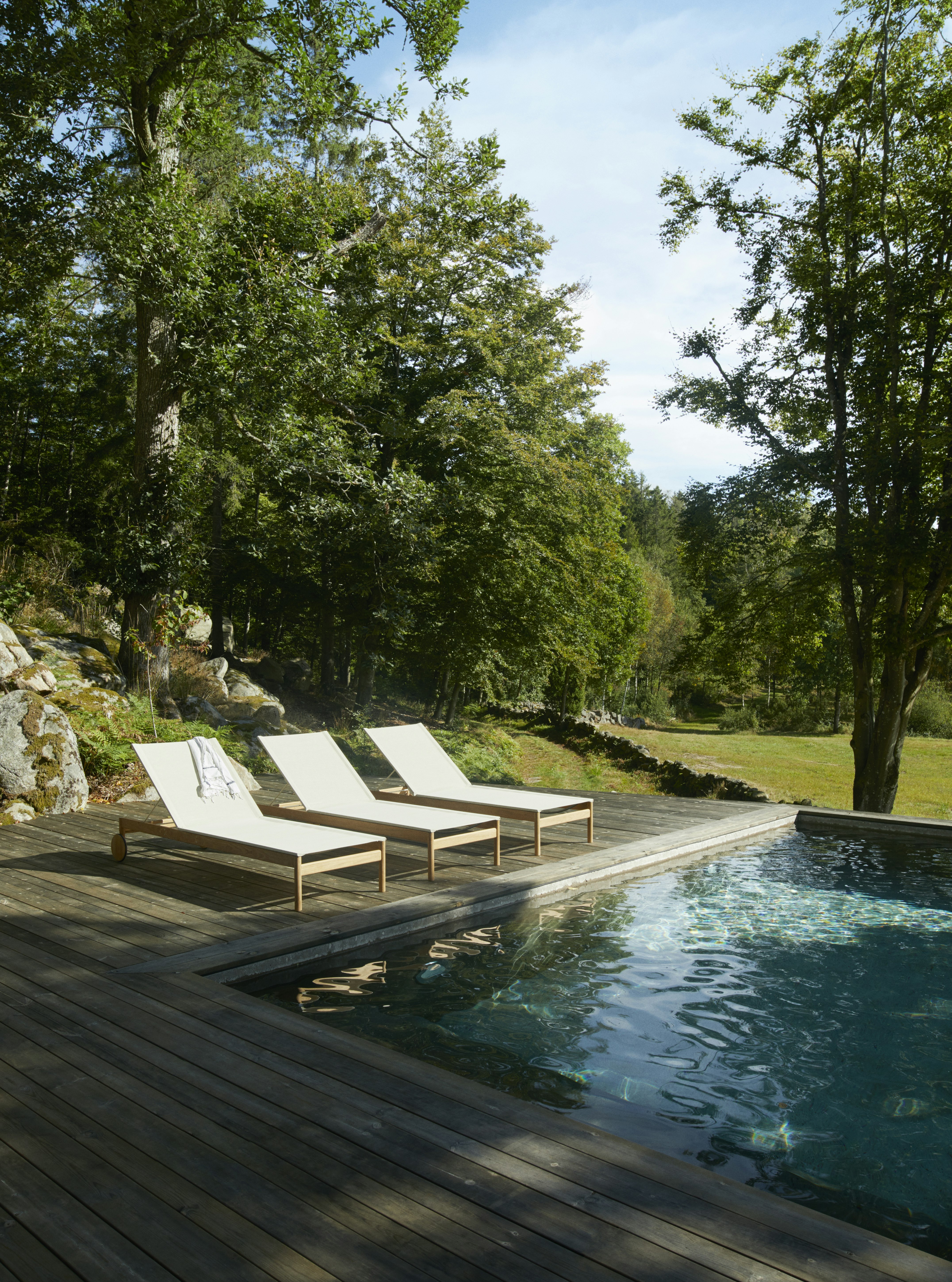 Three Pelagus Sunbeds at a poolside setting