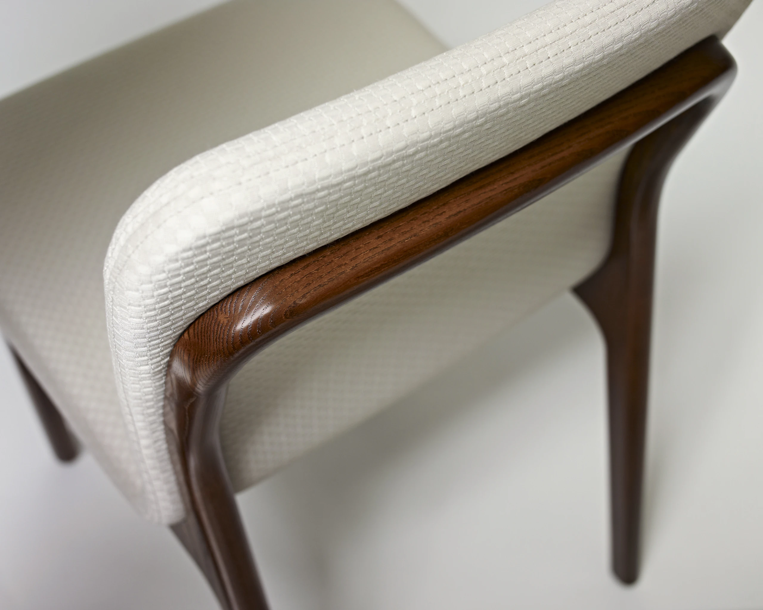 Extreme close-up of an arm on a Deft side chair.