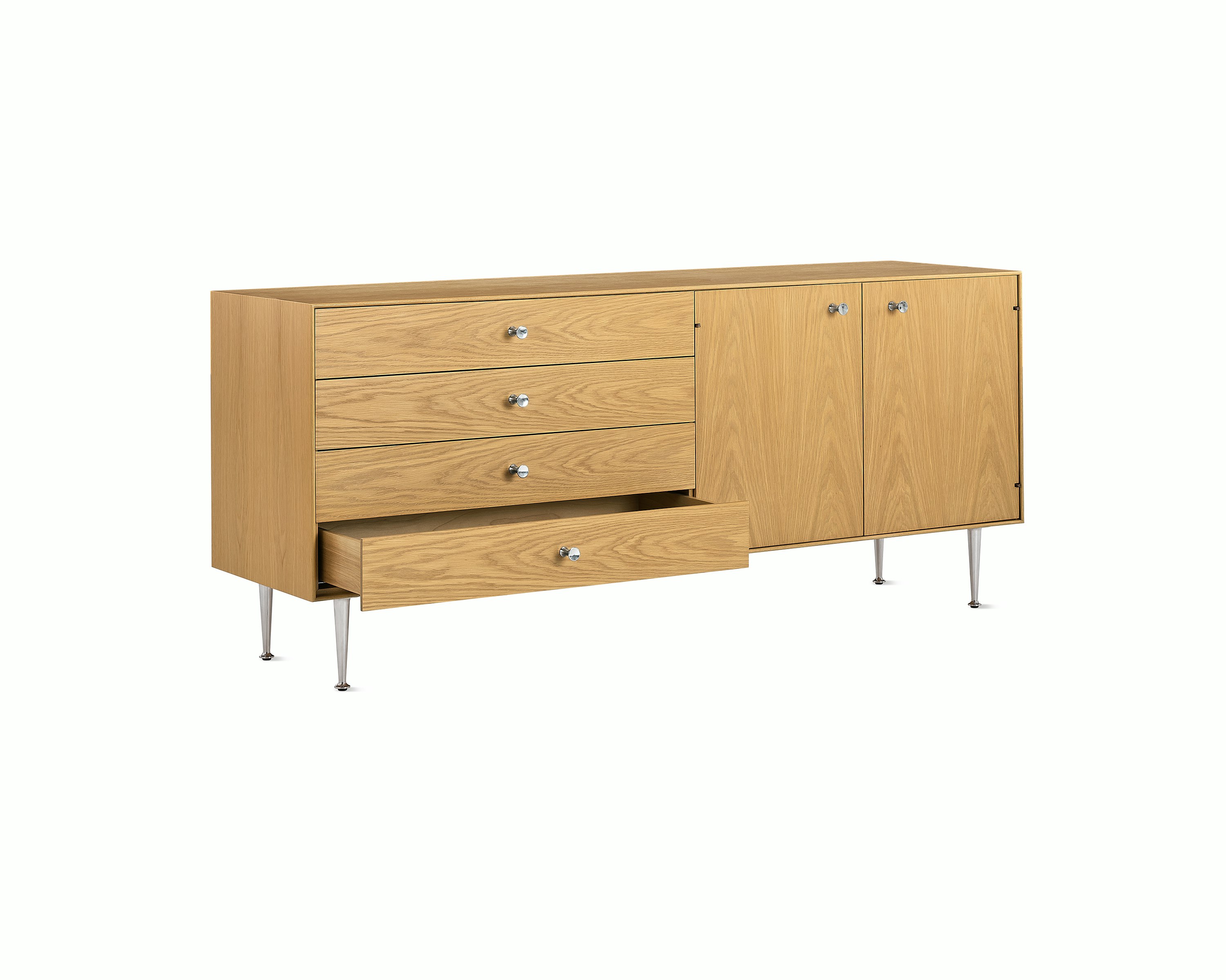 Light brown Nelson Thin Edge Buffet with one open drawer, viewed from an angle.